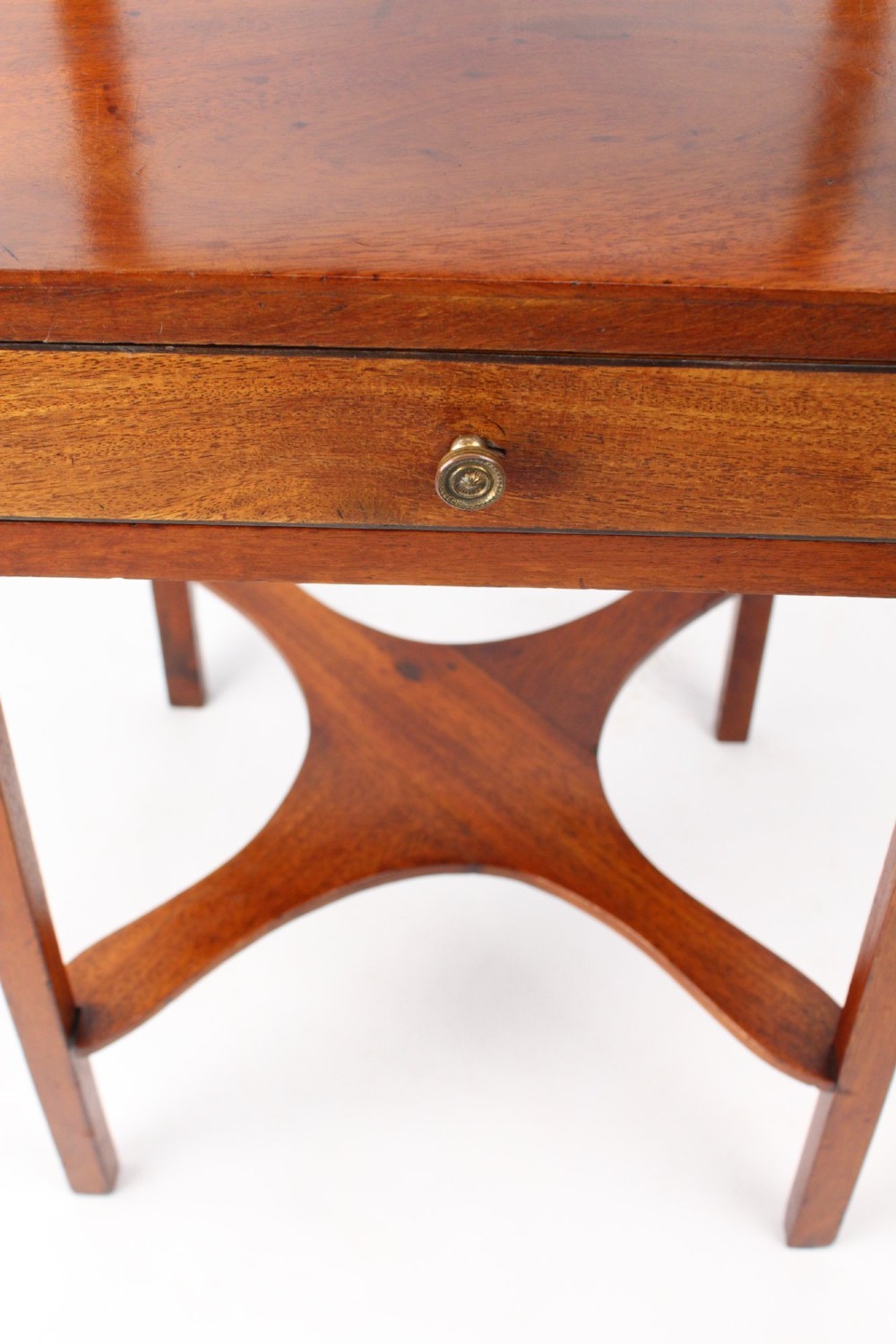 A two-tier Georgian mahogany bedside table with a single drawer, square top, and curved X-form stretcher. View VII