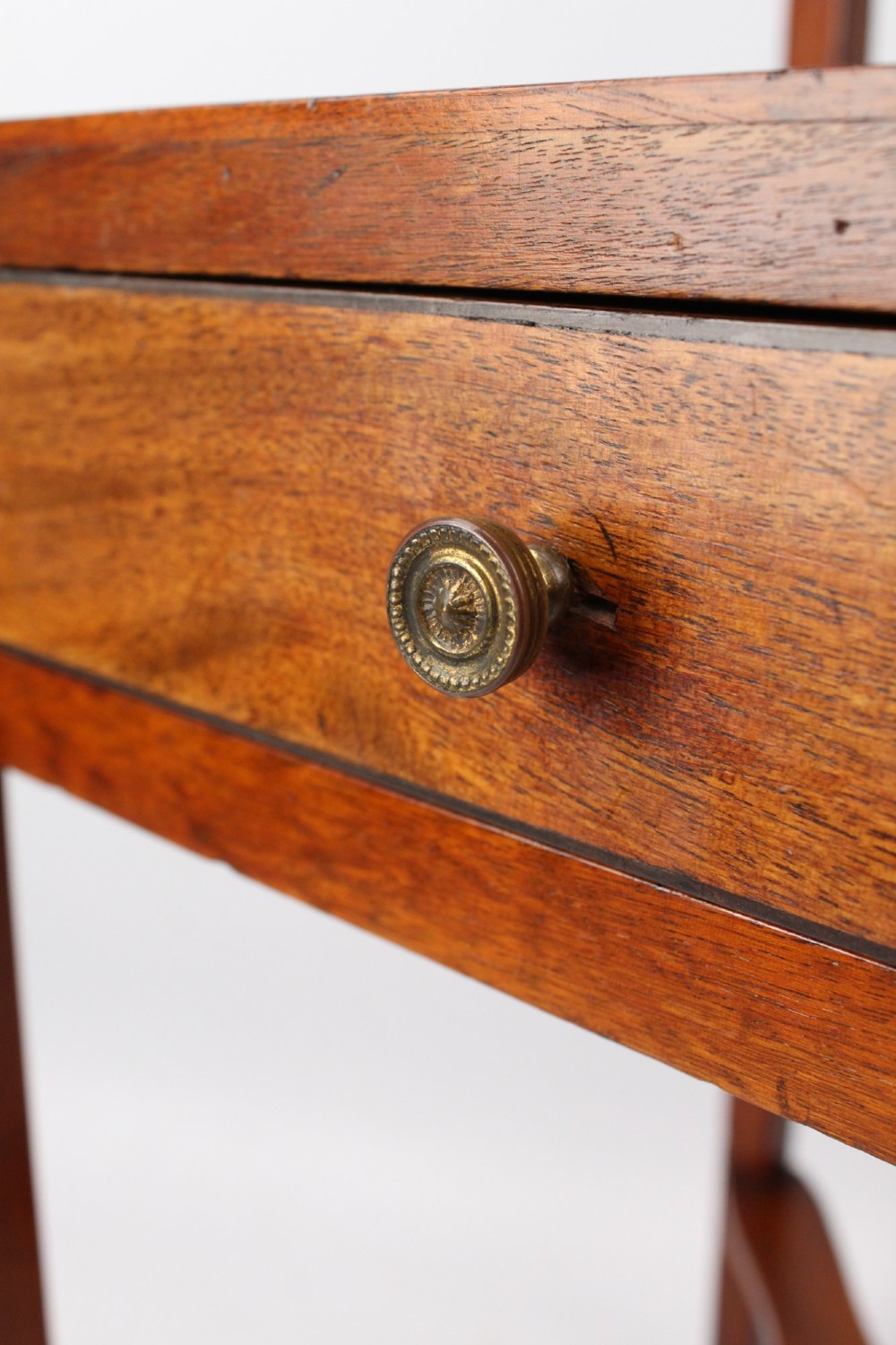 A two-tier Georgian mahogany bedside table with a single drawer, square top, and curved X-form stretcher. View VIII