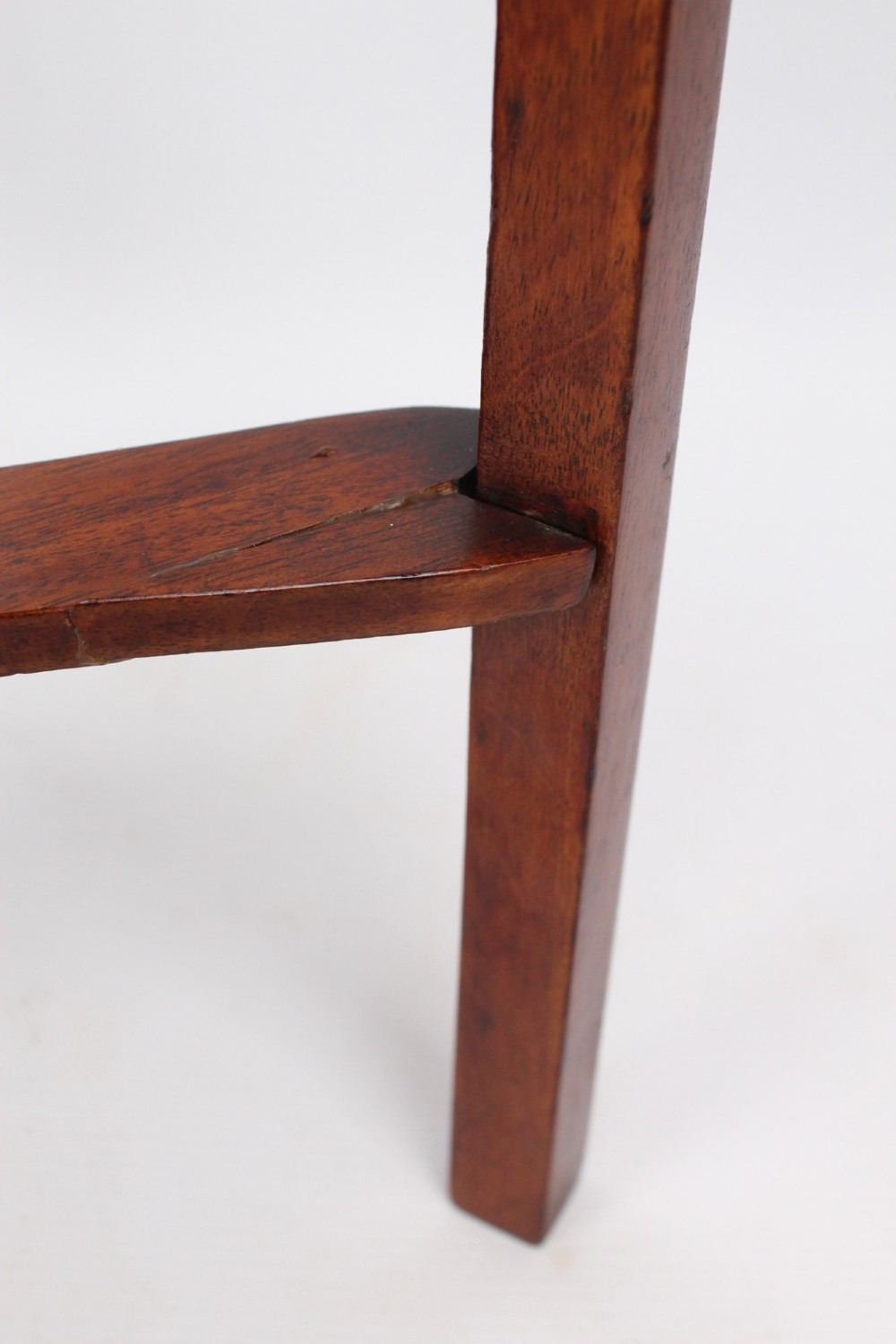 A two-tier Georgian mahogany bedside table with a single drawer, square top, and curved X-form stretcher. View X