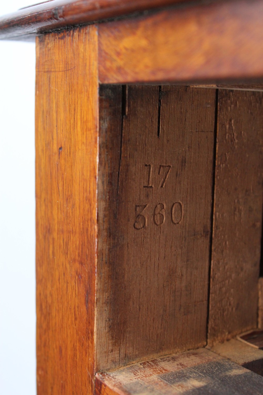 A Victorian mahogany writing table featuring a long frieze drawer with two turned wooden knobs, elevated on four ring-turned tapered legs. View V