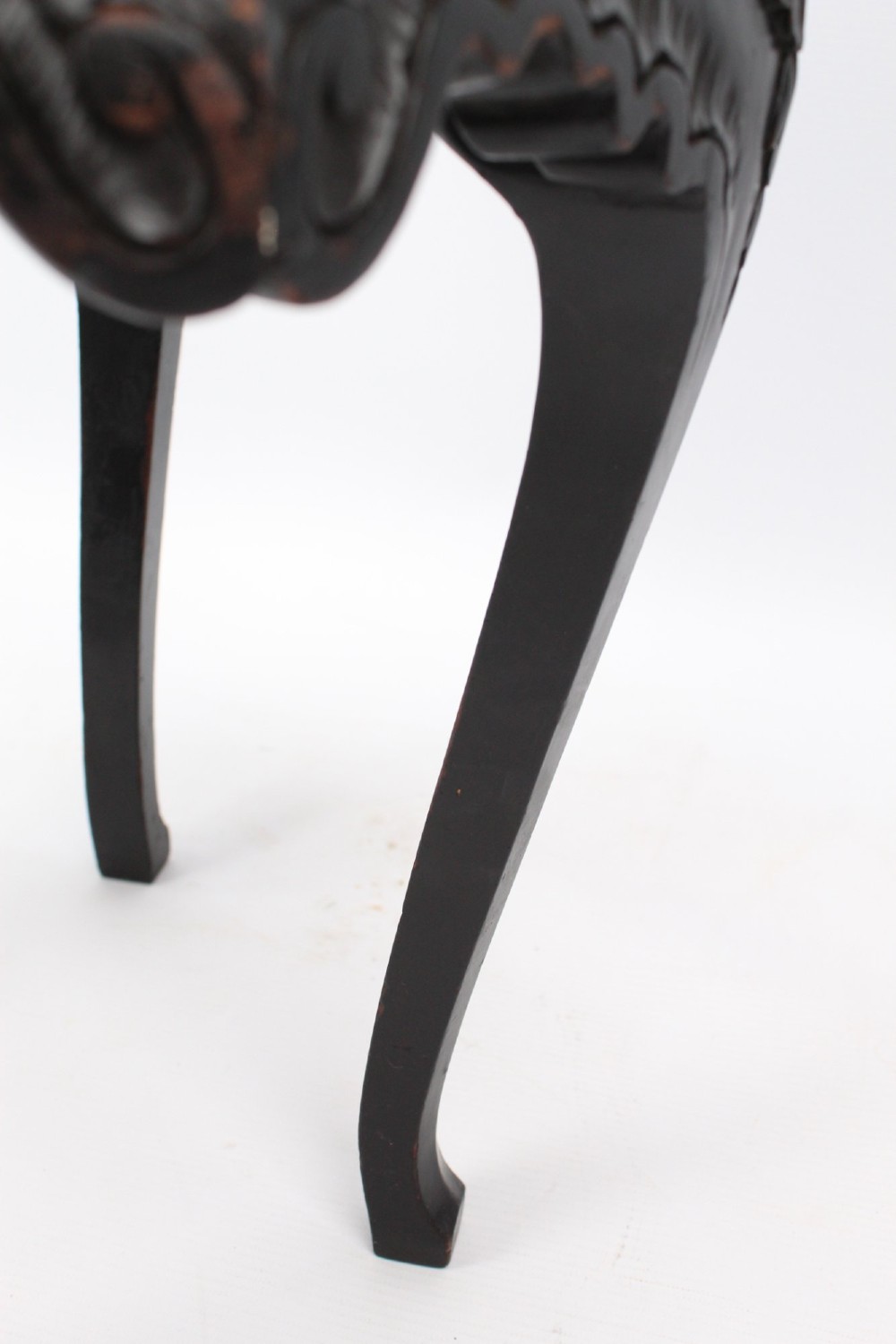 An antique ebonised hexagonal wooden coffee table featuring carved shell details along the apron and cabriole legs against a white background. View V