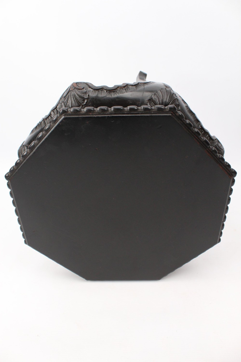 An antique ebonised hexagonal wooden coffee table featuring carved shell details along the apron and cabriole legs against a white background. View IX