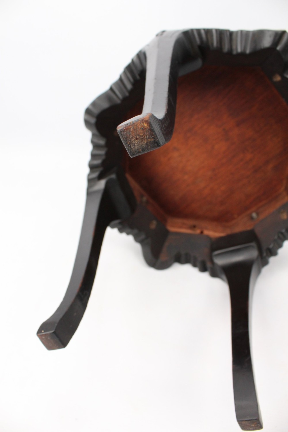An antique ebonised hexagonal wooden coffee table featuring carved shell details along the apron and cabriole legs against a white background. View XI