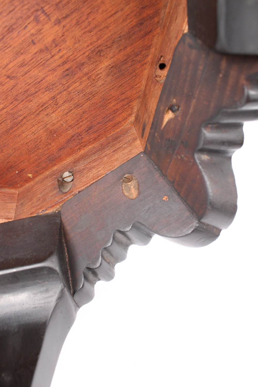 An antique ebonised hexagonal wooden coffee table featuring carved shell details along the apron and cabriole legs against a white background. View XII