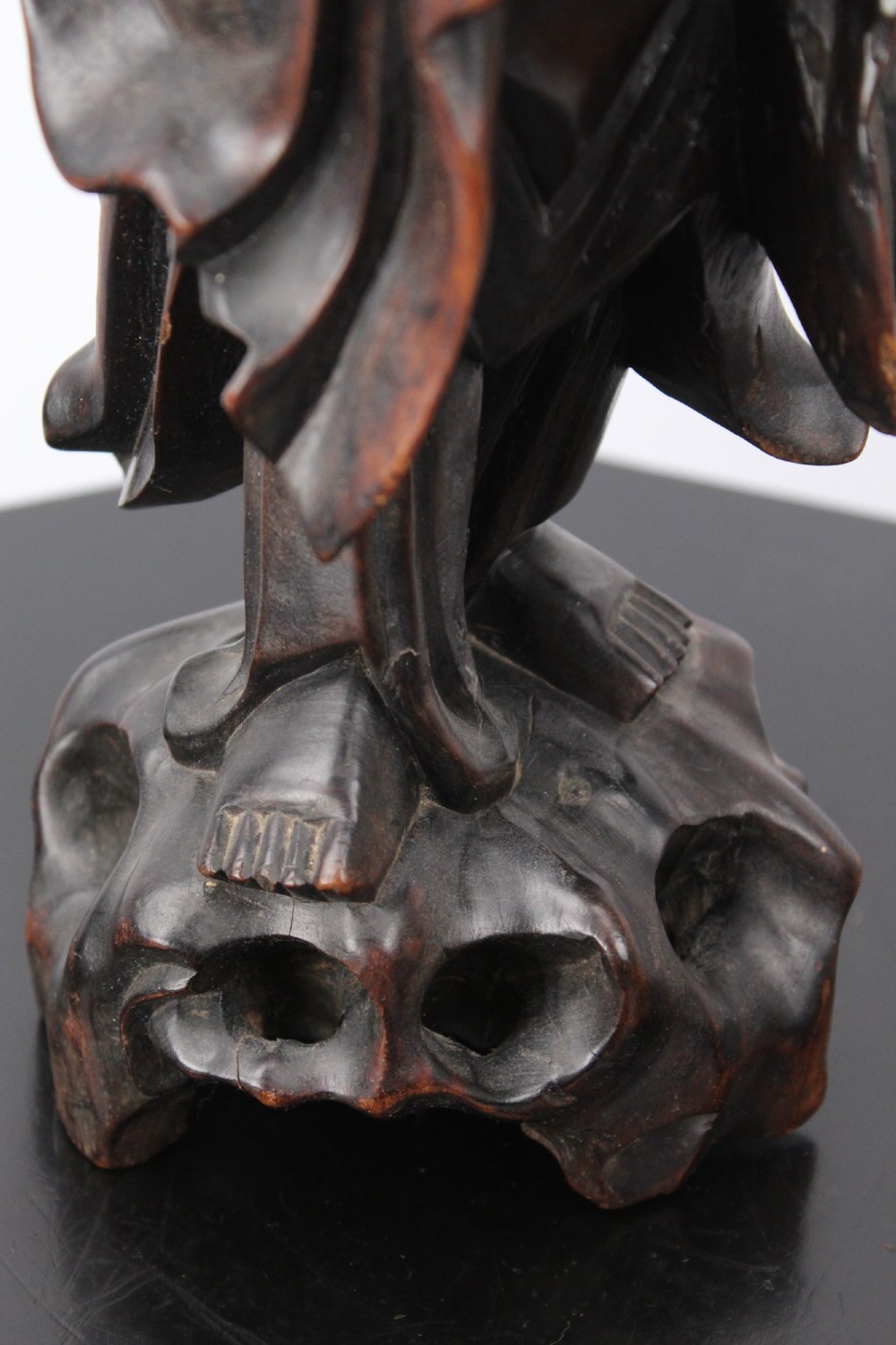 A hand-carved dark wood figure of the Daoist Immortal Liu Hai holding a three-legged toad, set upon a carved rockwork base with a brass lamp fitting at the top. View VI