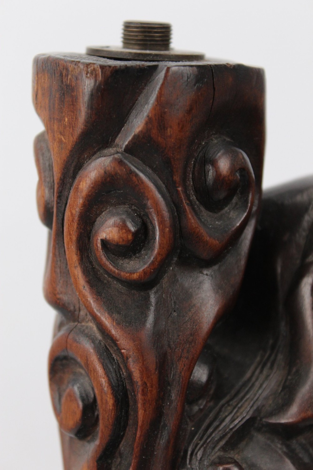 A hand-carved dark wood figure of the Daoist Immortal Liu Hai holding a three-legged toad, set upon a carved rockwork base with a brass lamp fitting at the top. View VII