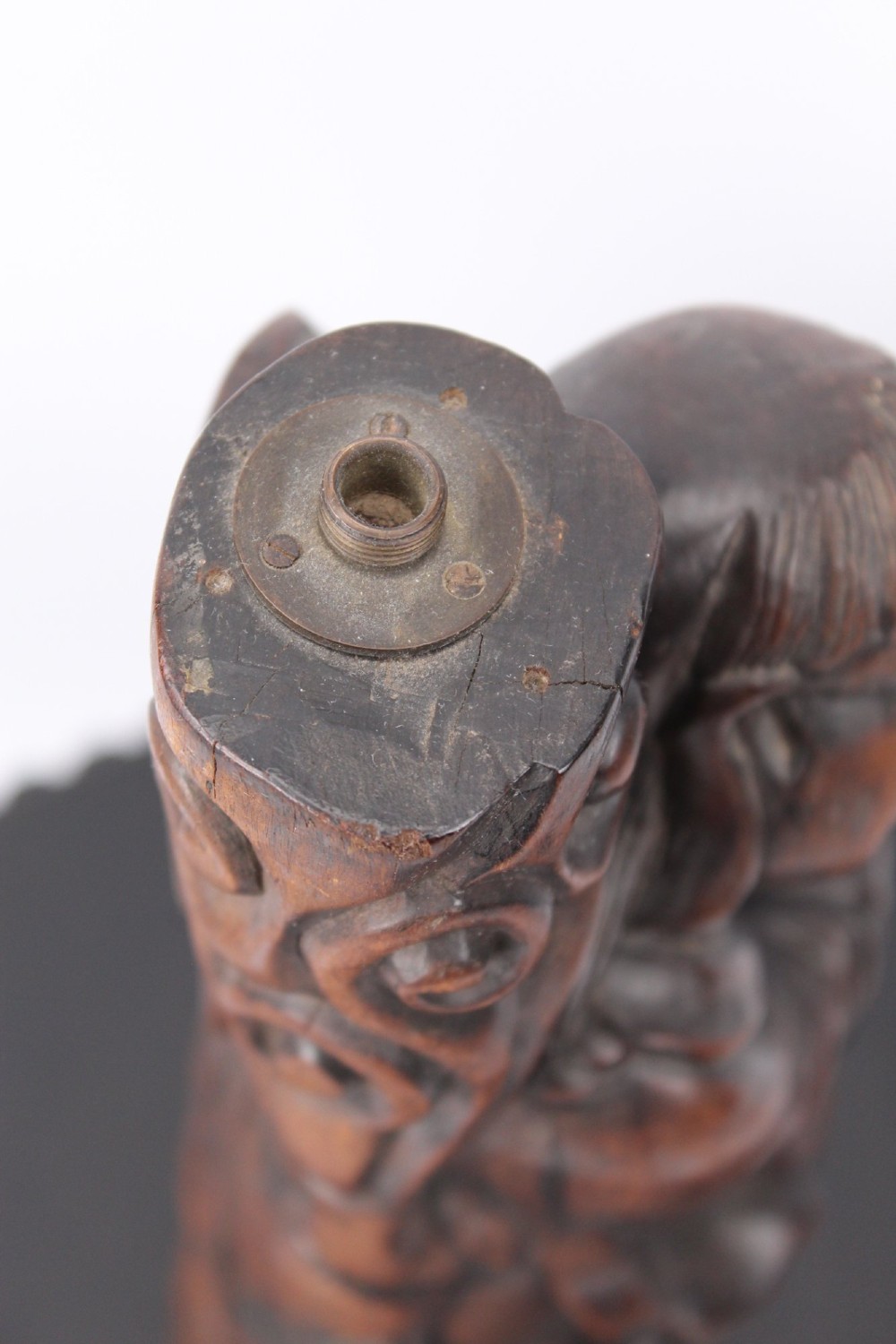 A hand-carved dark wood figure of the Daoist Immortal Liu Hai holding a three-legged toad, set upon a carved rockwork base with a brass lamp fitting at the top. View VIII