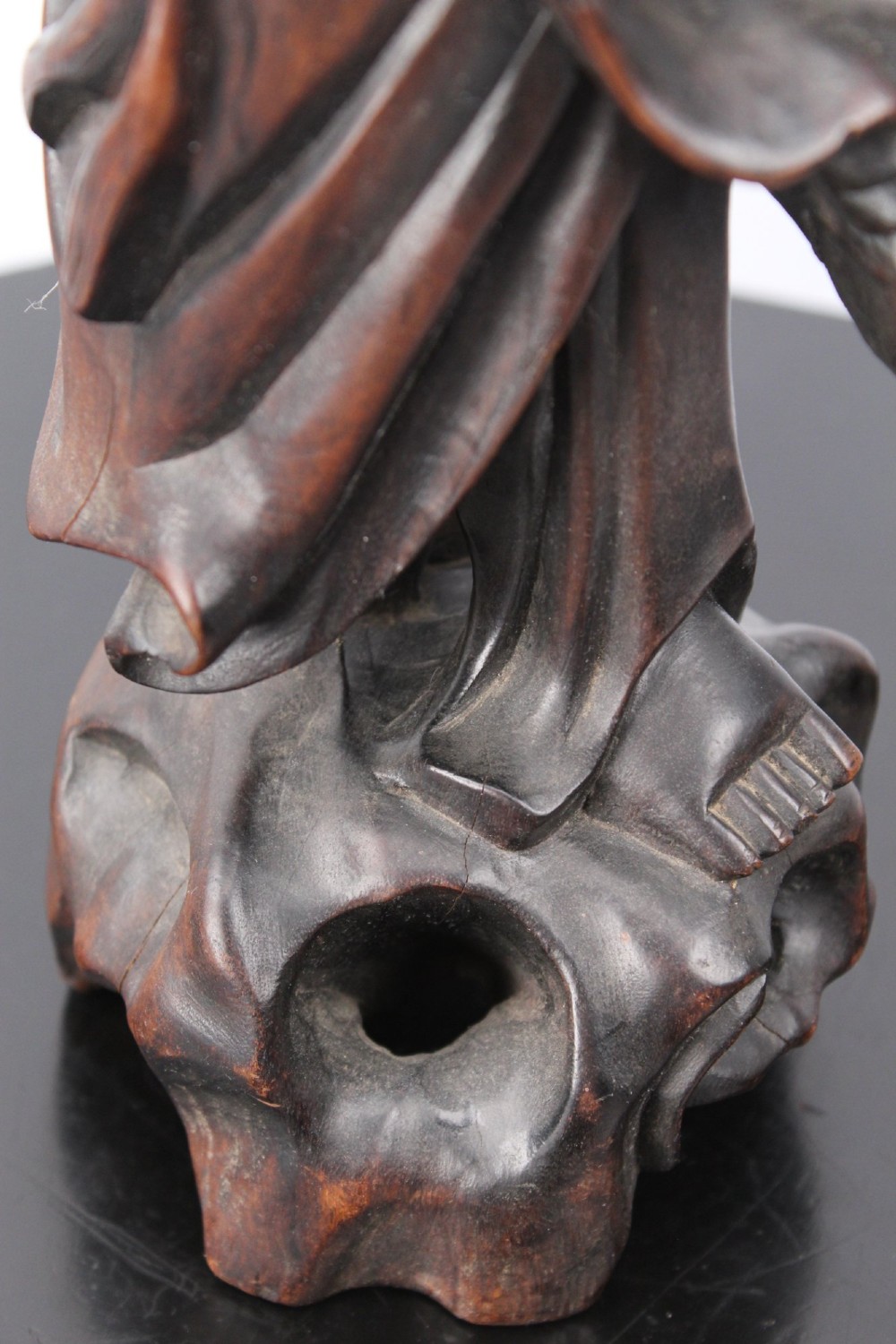 A hand-carved dark wood figure of the Daoist Immortal Liu Hai holding a three-legged toad, set upon a carved rockwork base with a brass lamp fitting at the top. View X