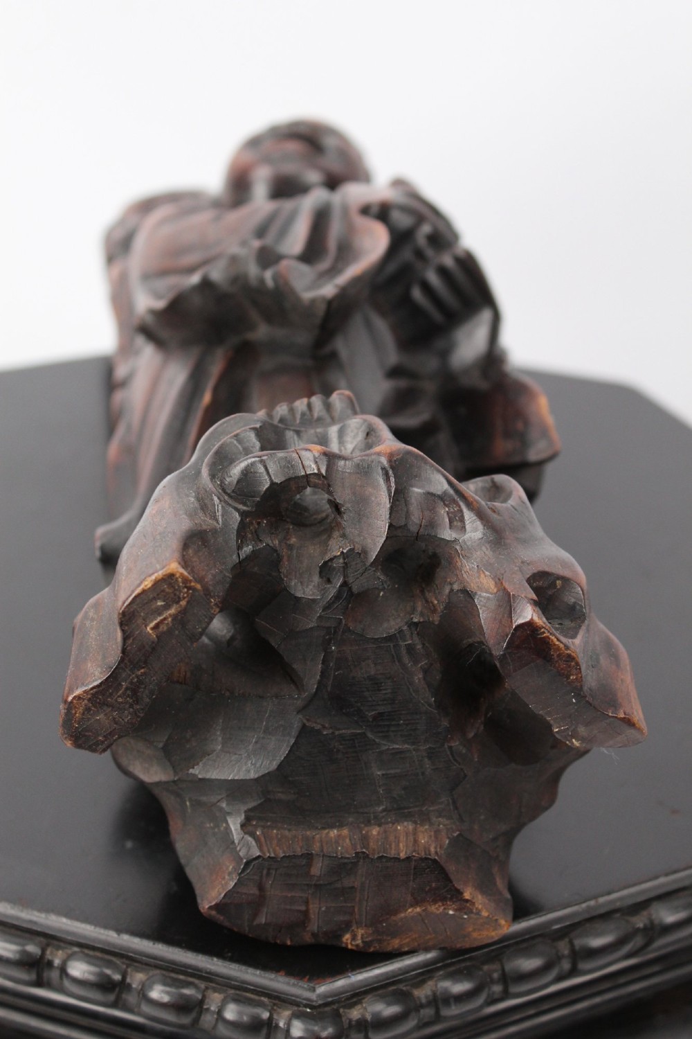 A hand-carved dark wood figure of the Daoist Immortal Liu Hai holding a three-legged toad, set upon a carved rockwork base with a brass lamp fitting at the top. View XI