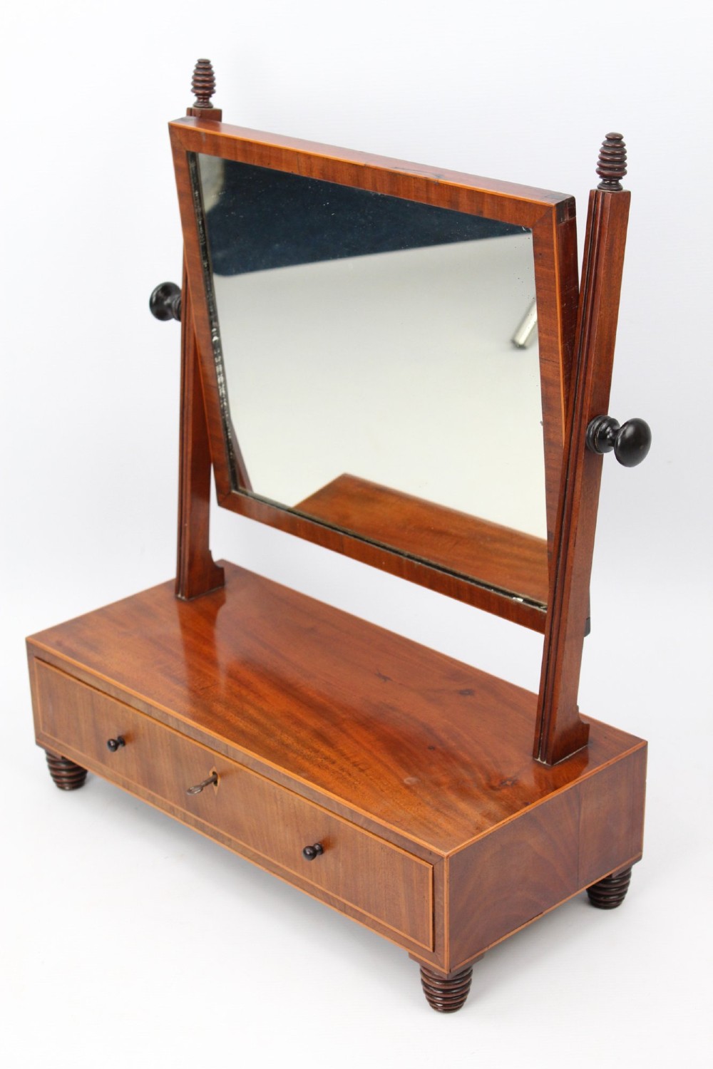 An antique Regency mahogany toilet mirror featuring an adjustable rectangular mirror set between turned upright posts above a single drawer base. View II