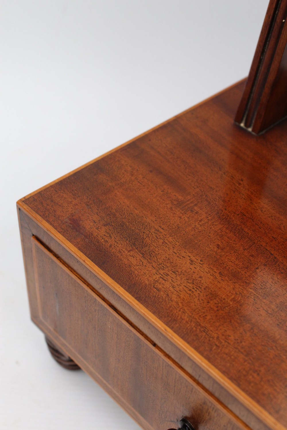 An antique Regency mahogany toilet mirror featuring an adjustable rectangular mirror set between turned upright posts above a single drawer base. View IX