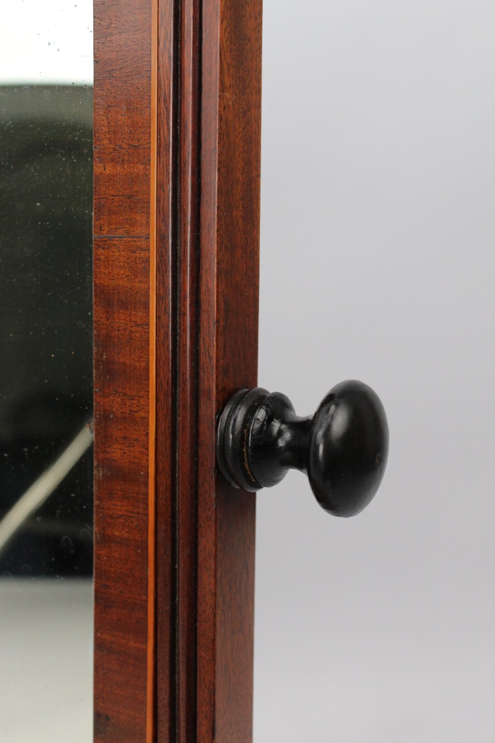 An antique Regency mahogany toilet mirror featuring an adjustable rectangular mirror set between turned upright posts above a single drawer base. View XI