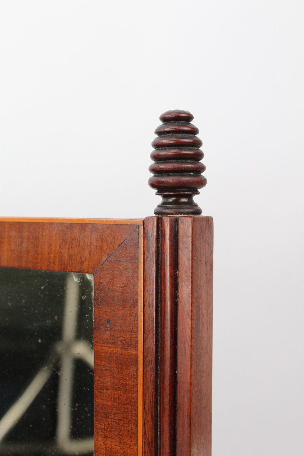 An antique Regency mahogany toilet mirror featuring an adjustable rectangular mirror set between turned upright posts above a single drawer base. View XII