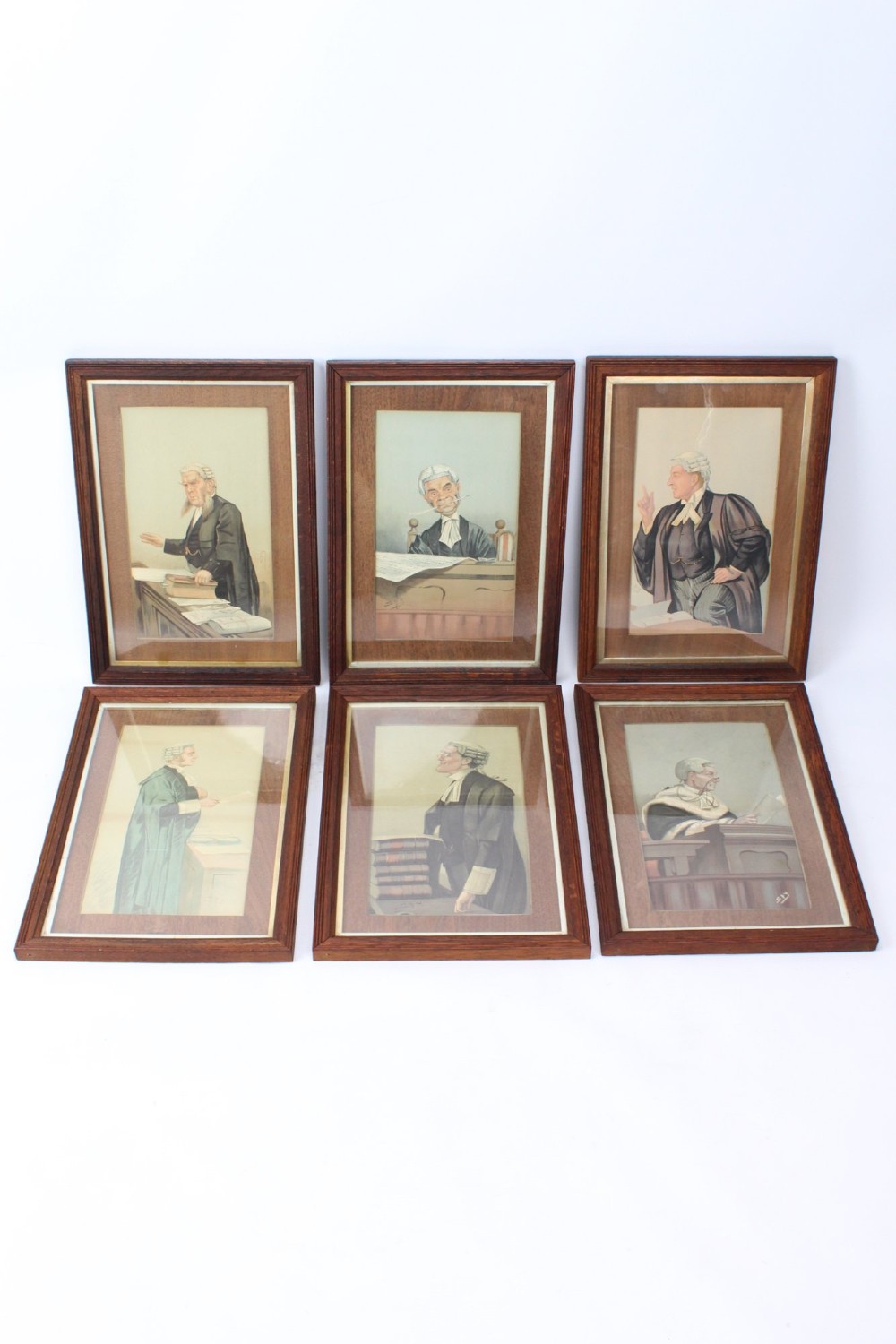 A set of six framed antique Vanity Fair lithographs featuring caricatures of judges and barristers in legal robes and wigs, presented in dark wood frames with gilt slips.