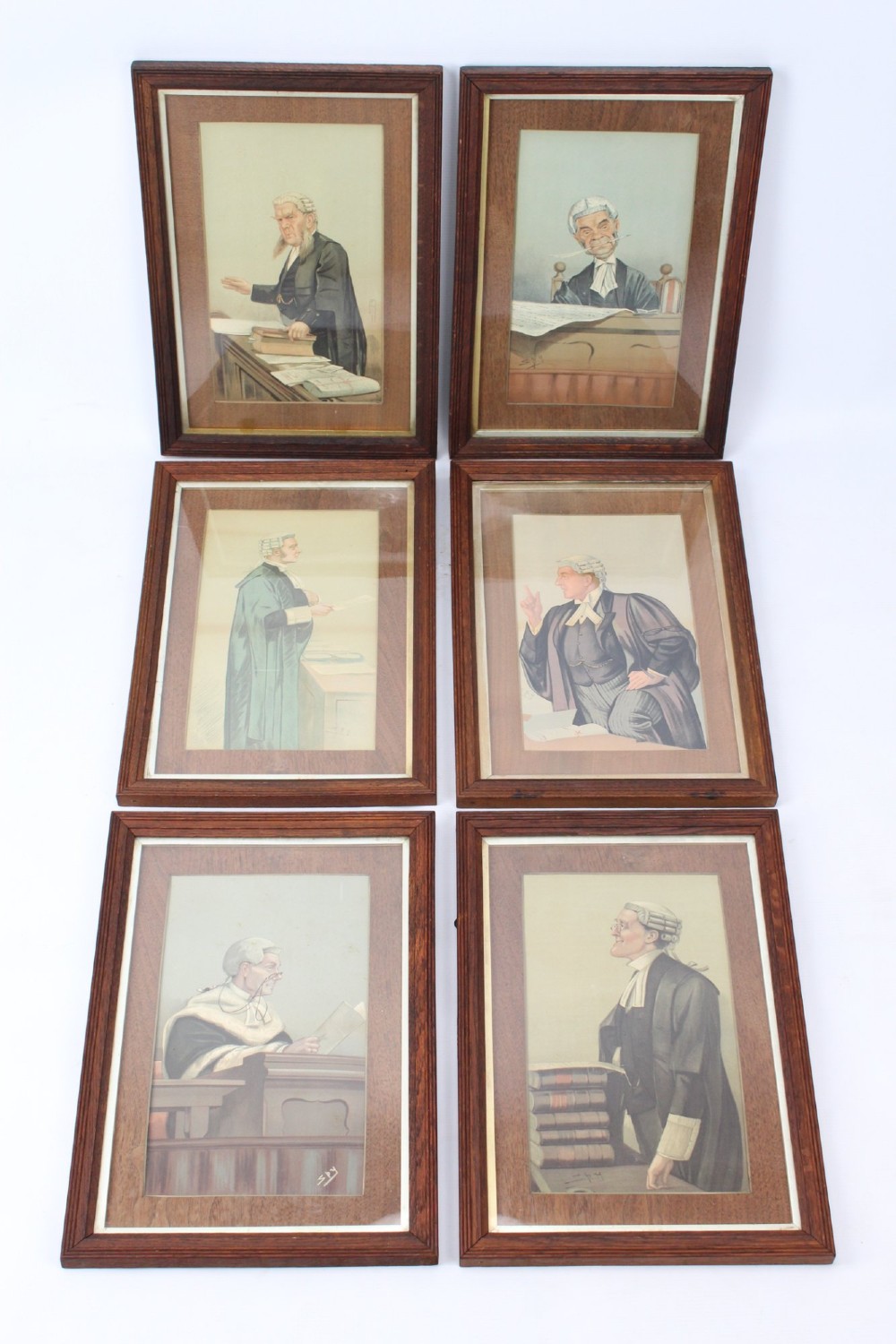 A set of six framed antique Vanity Fair lithographs featuring caricatures of judges and barristers in legal robes and wigs, presented in dark wood frames with gilt slips. View II