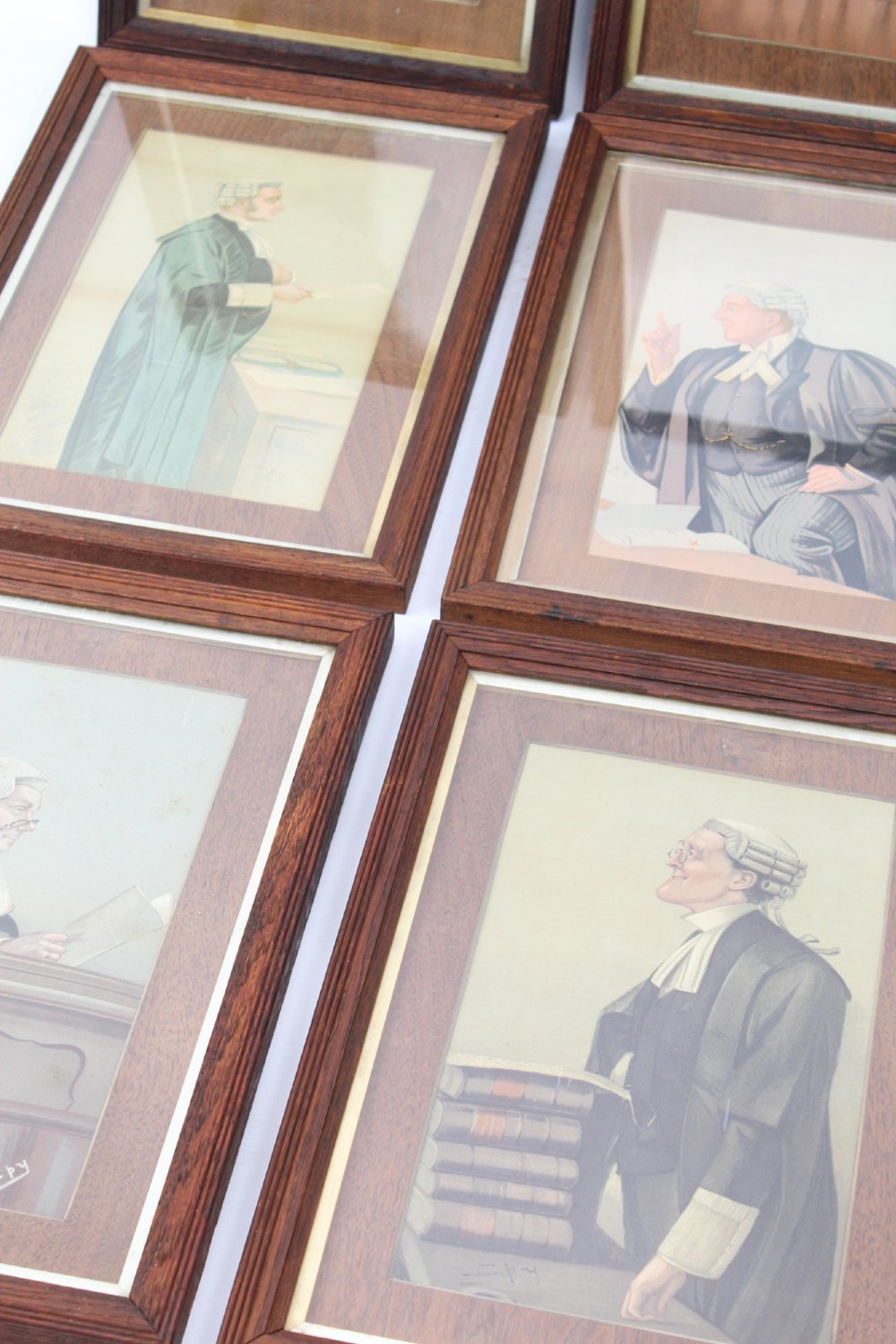 A set of six framed antique Vanity Fair lithographs featuring caricatures of judges and barristers in legal robes and wigs, presented in dark wood frames with gilt slips. View III