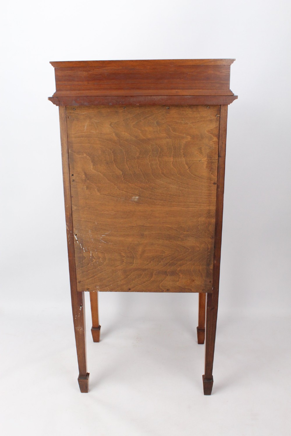 An Edwardian mahogany music cabinet featuring six shallow drawers with brass handles, set on slender square tapered legs with a raised gallery back. View XIII