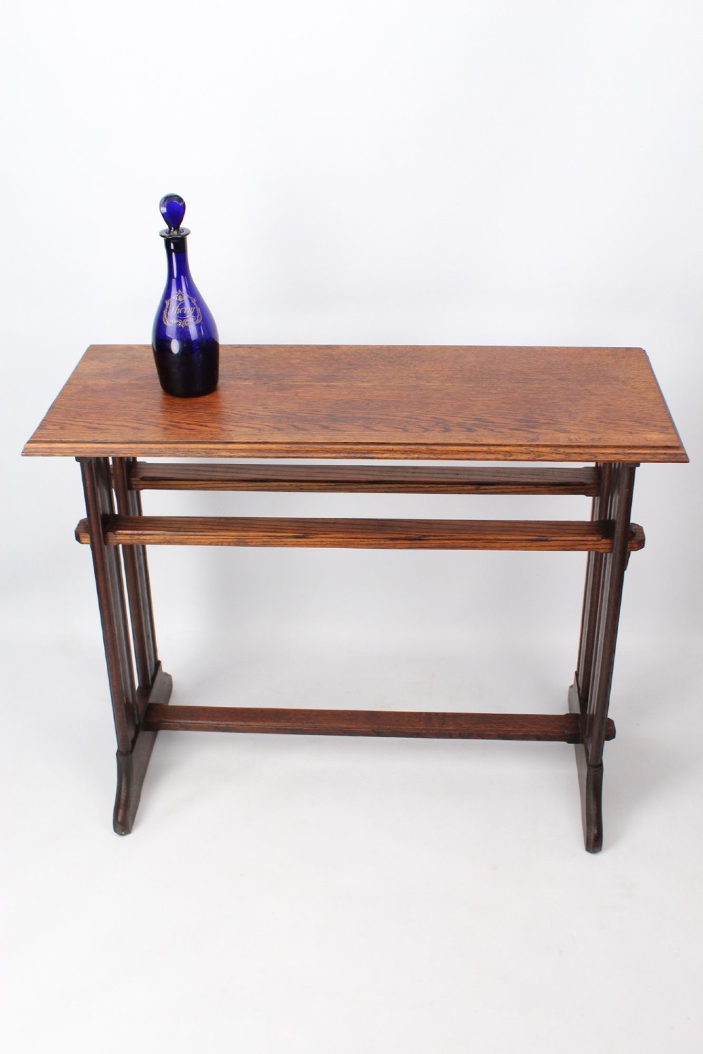 An Edwardian Arts and Crafts medium brown oak side table featuring double upright supports, exposed joint details, and a low stretcher. View II