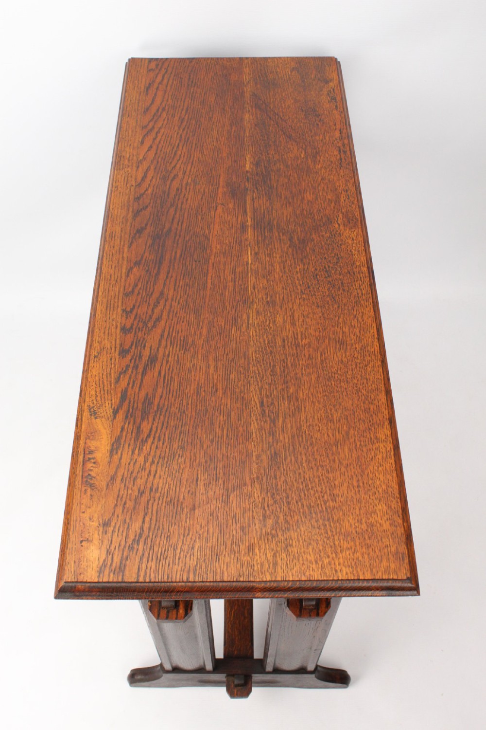 An Edwardian Arts and Crafts medium brown oak side table featuring double upright supports, exposed joint details, and a low stretcher. View V