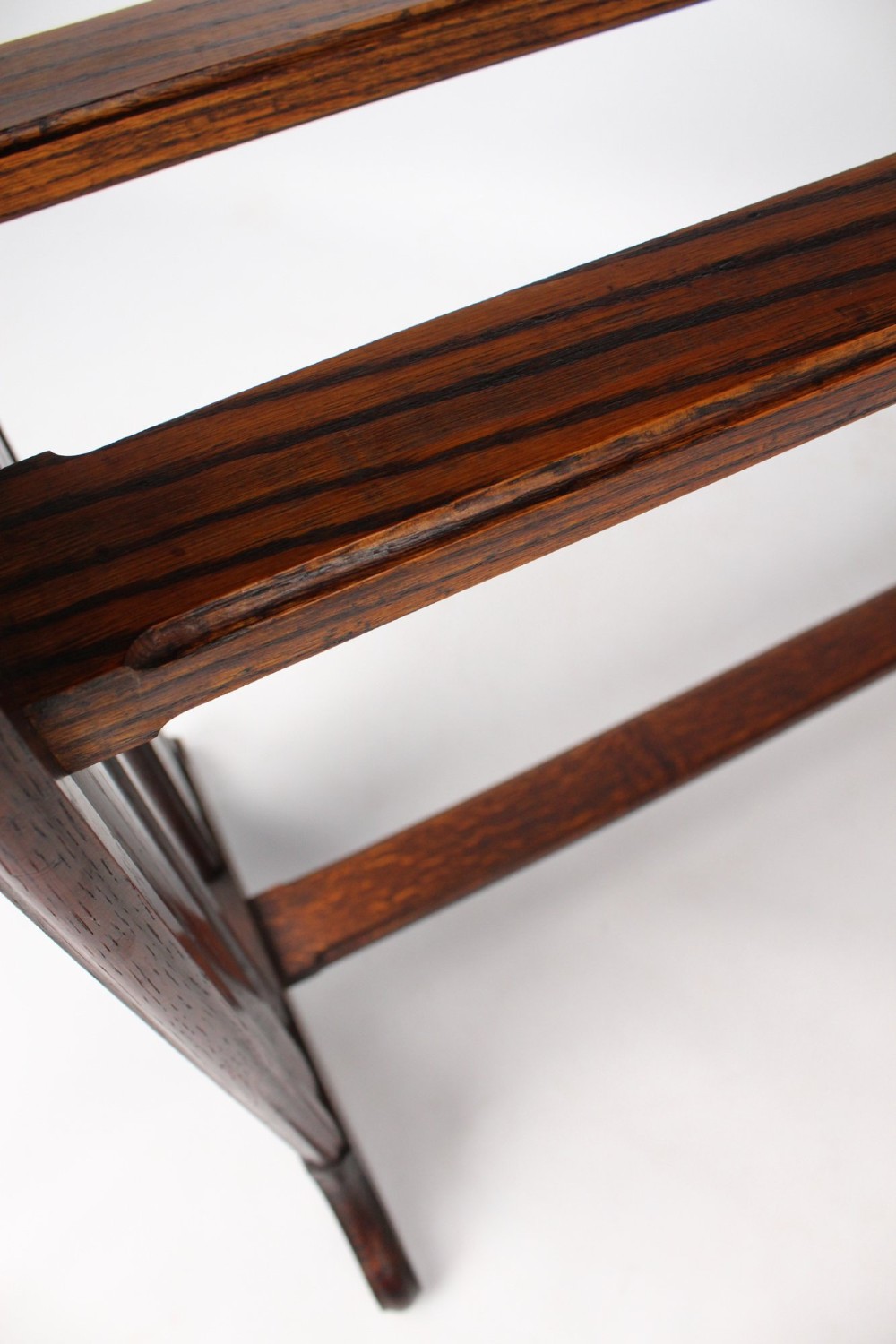 An Edwardian Arts and Crafts medium brown oak side table featuring double upright supports, exposed joint details, and a low stretcher. View IX