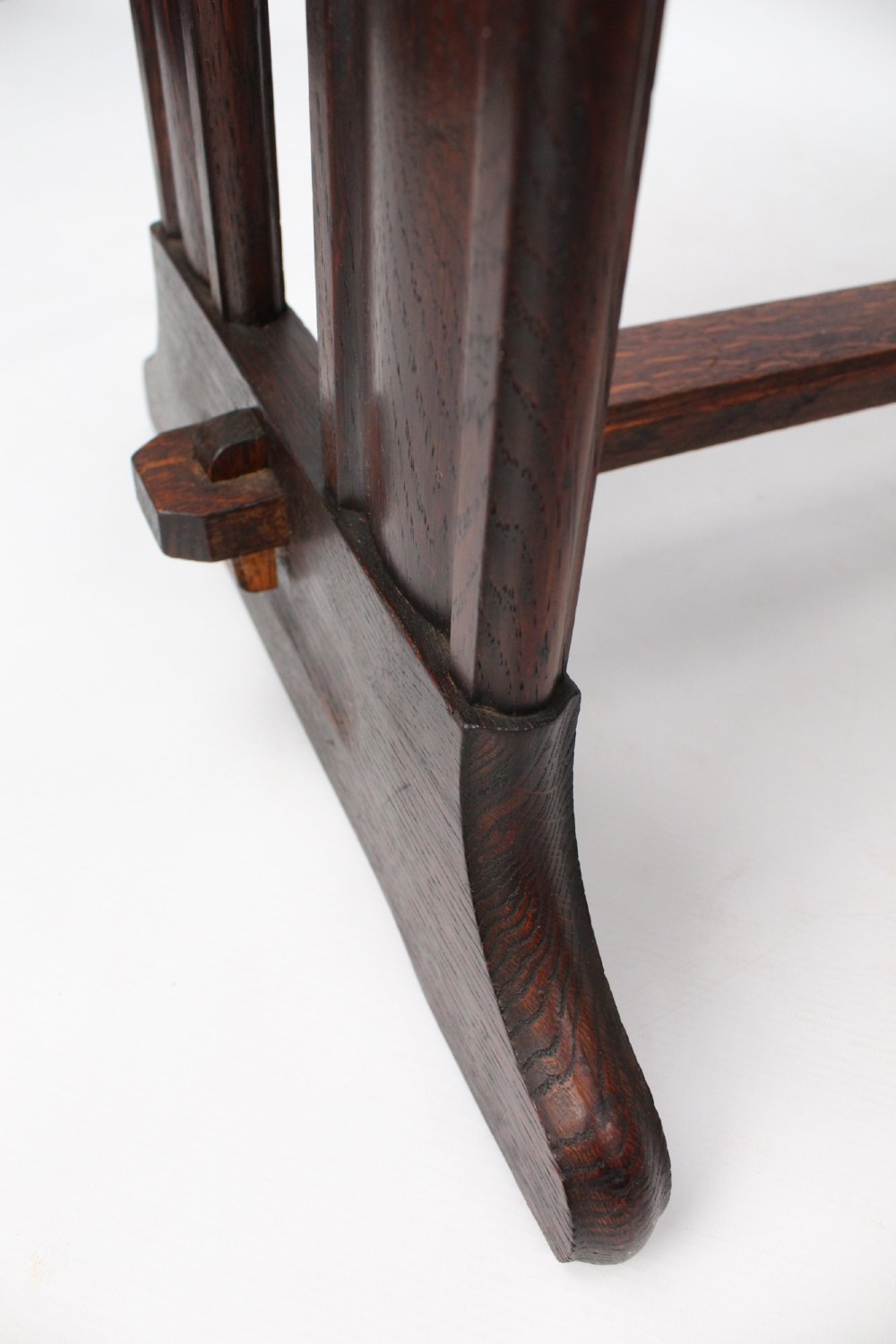 An Edwardian Arts and Crafts medium brown oak side table featuring double upright supports, exposed joint details, and a low stretcher. View XI