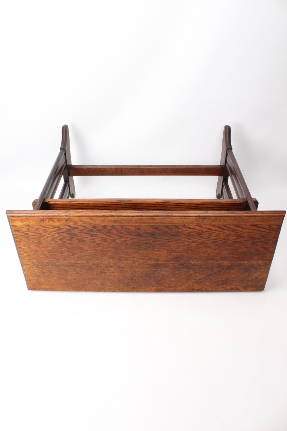 An Edwardian Arts and Crafts medium brown oak side table featuring double upright supports, exposed joint details, and a low stretcher. View XII