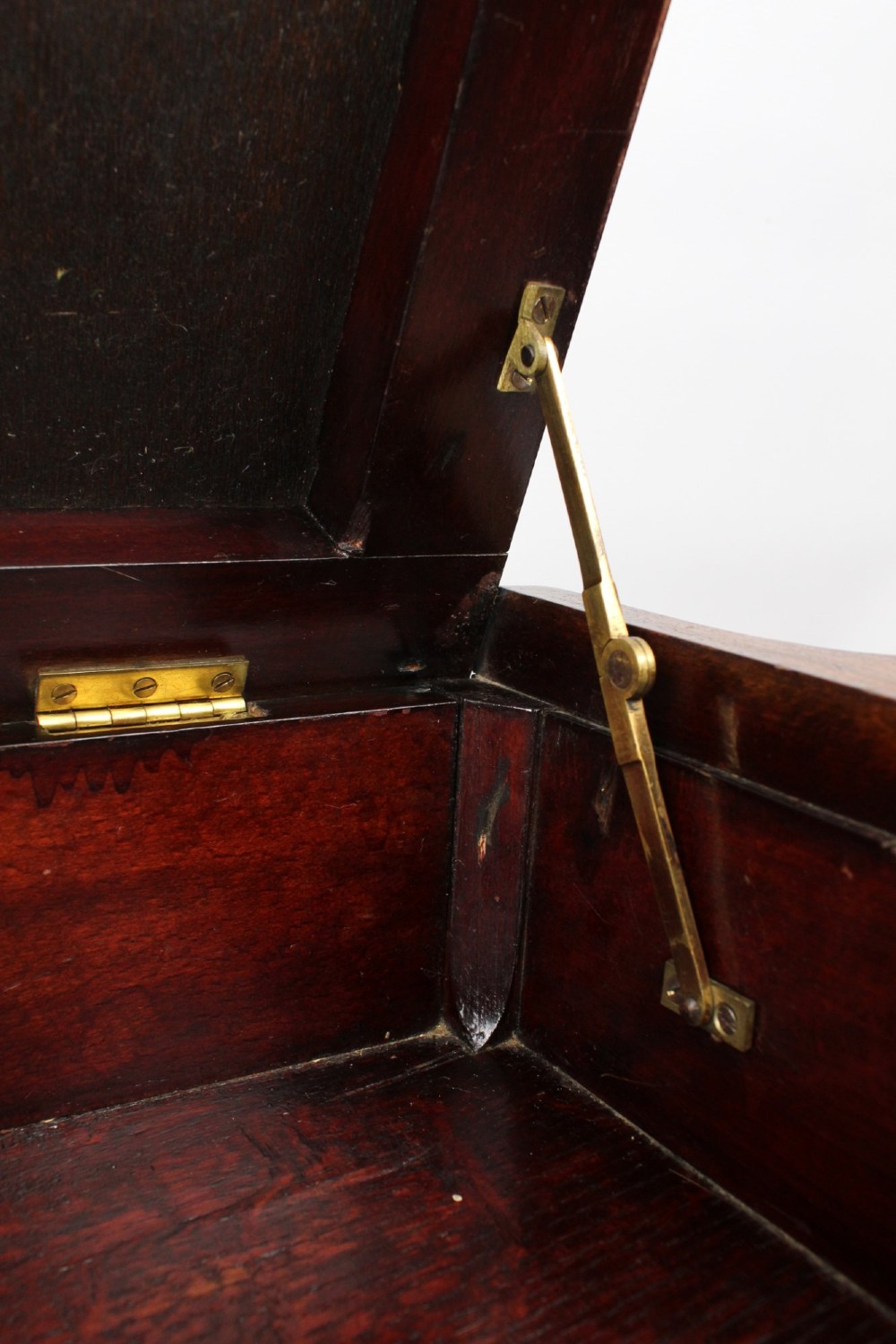 An Edwardian wooden duet piano stool featuring an olive green velvet upholstered seat and slender tapered legs. View VI
