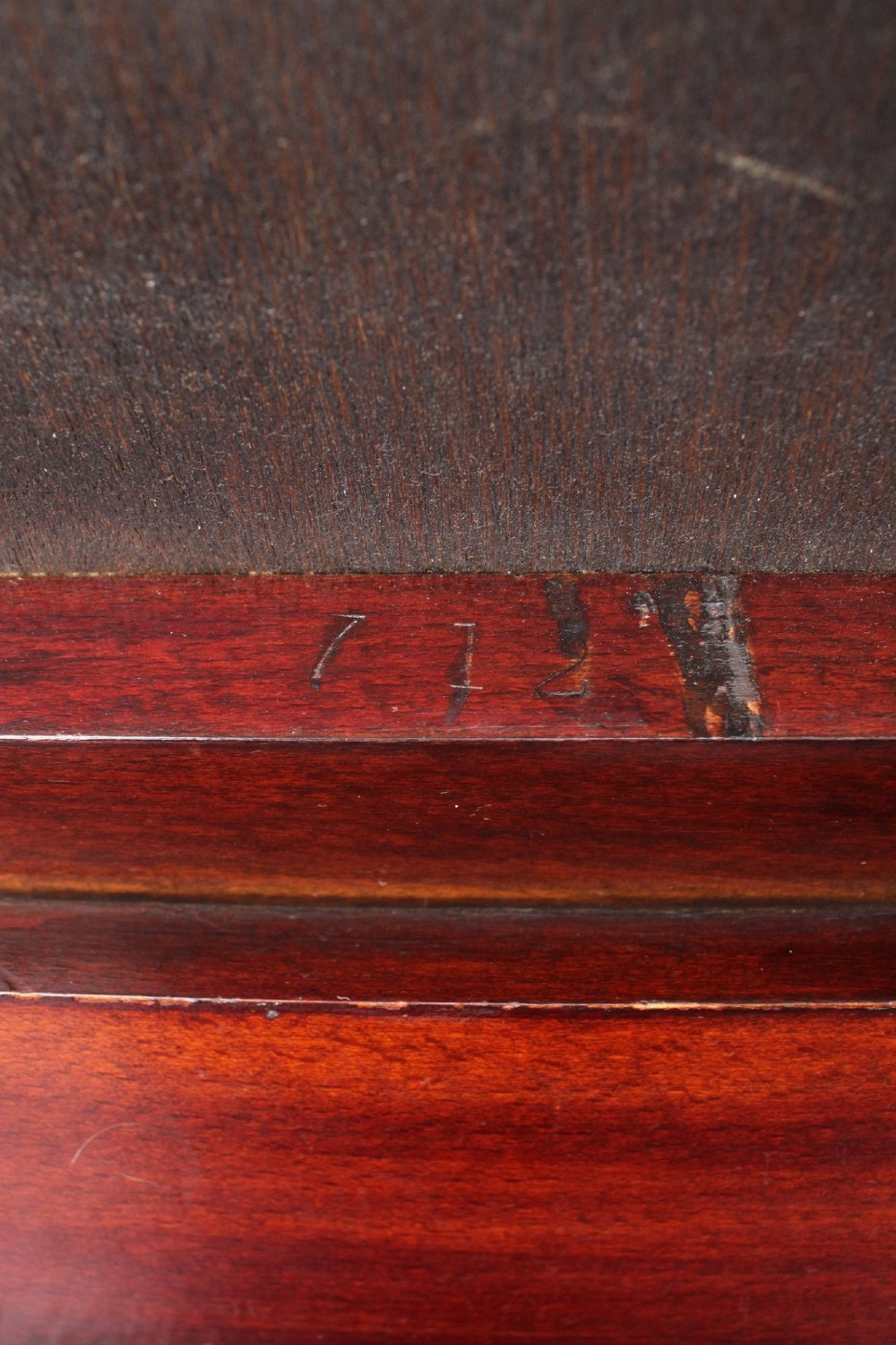 An Edwardian wooden duet piano stool featuring an olive green velvet upholstered seat and slender tapered legs. View VII