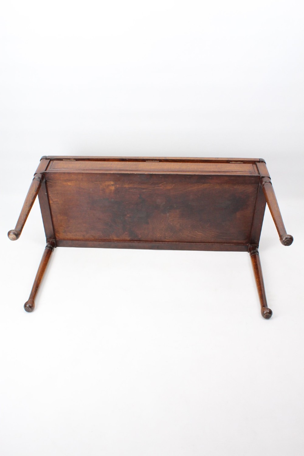 An Edwardian wooden duet piano stool featuring an olive green velvet upholstered seat and slender tapered legs. View VIII