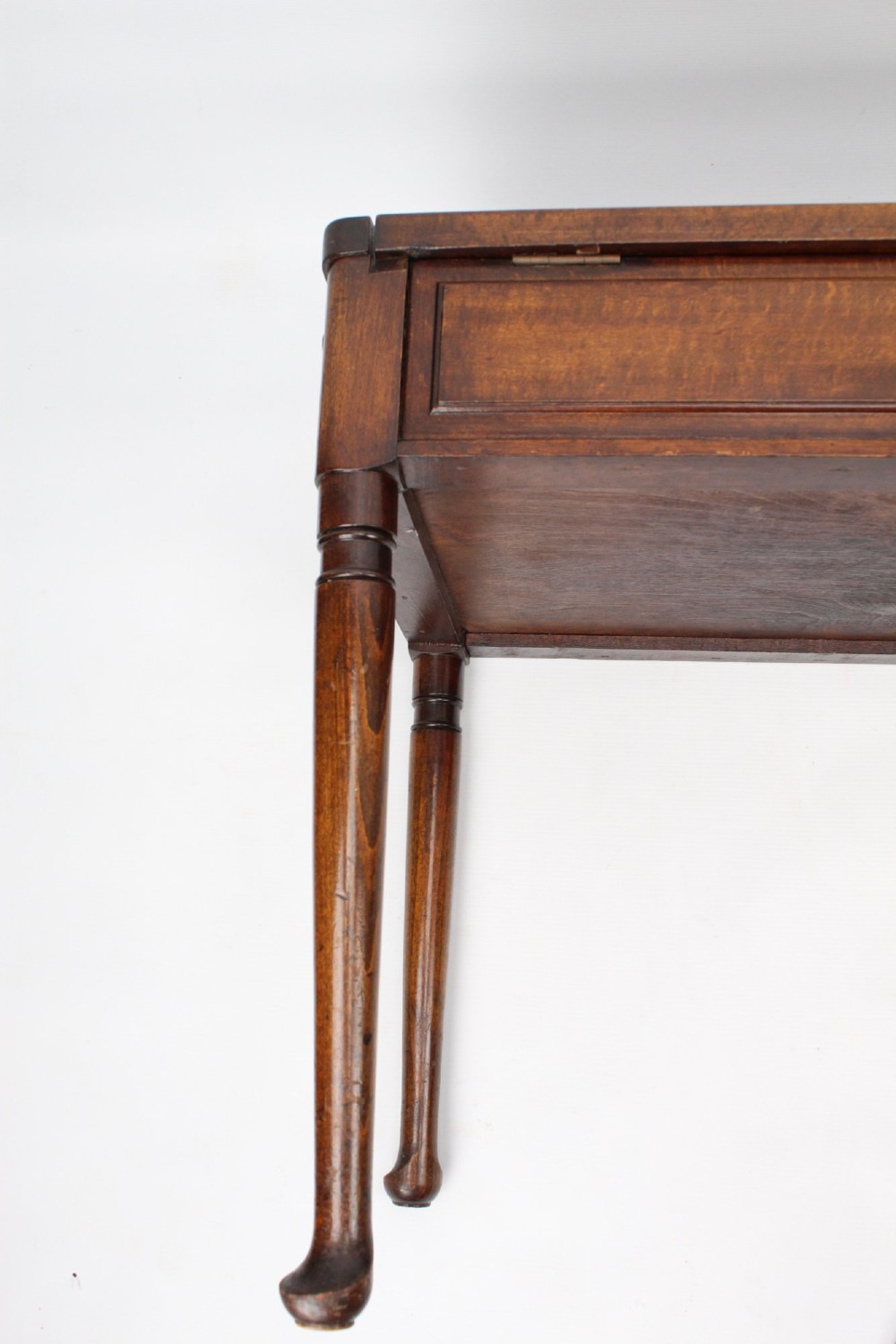 An Edwardian wooden duet piano stool featuring an olive green velvet upholstered seat and slender tapered legs. View IX