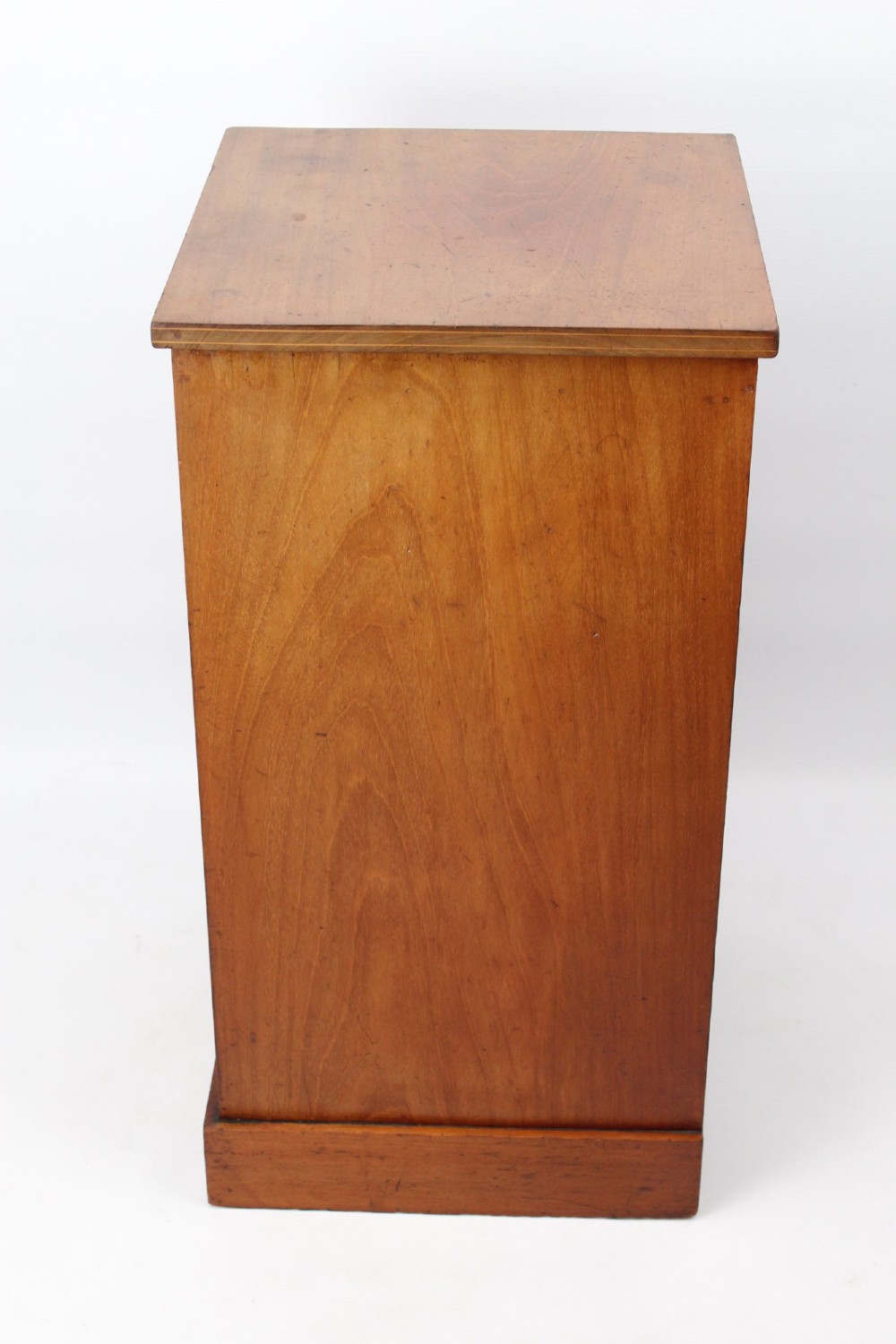 A small Edwardian mahogany bedside cabinet featuring fine boxwood string inlay on the single cupboard door and a brass drop handle. View IV
