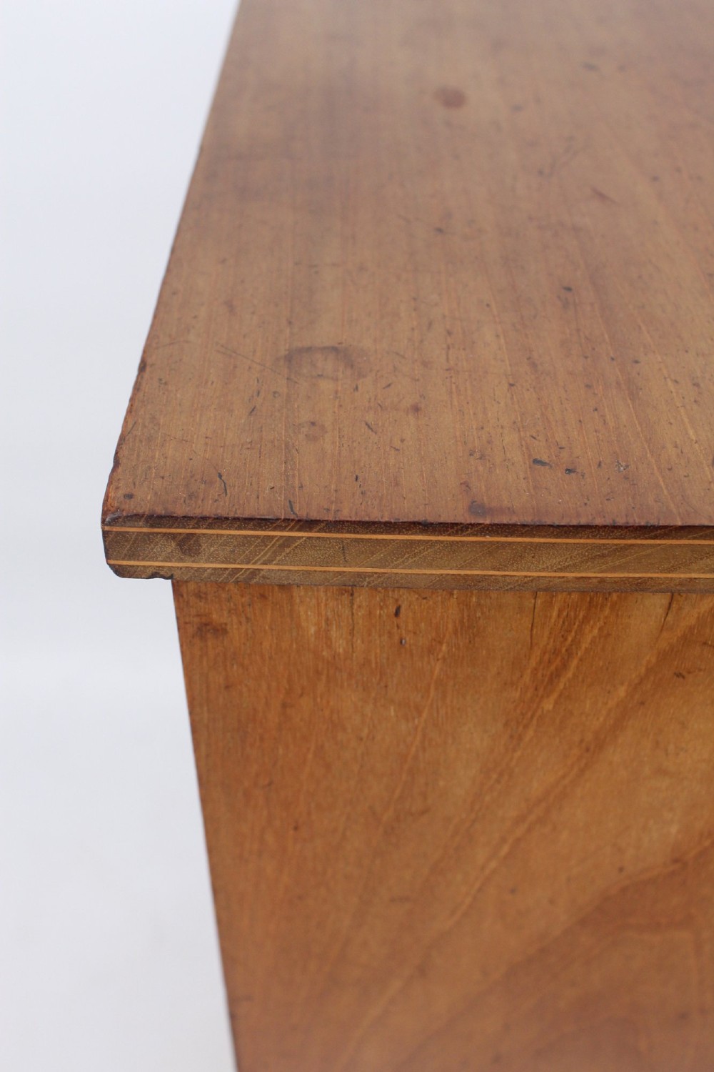 A small Edwardian mahogany bedside cabinet featuring fine boxwood string inlay on the single cupboard door and a brass drop handle. View VII