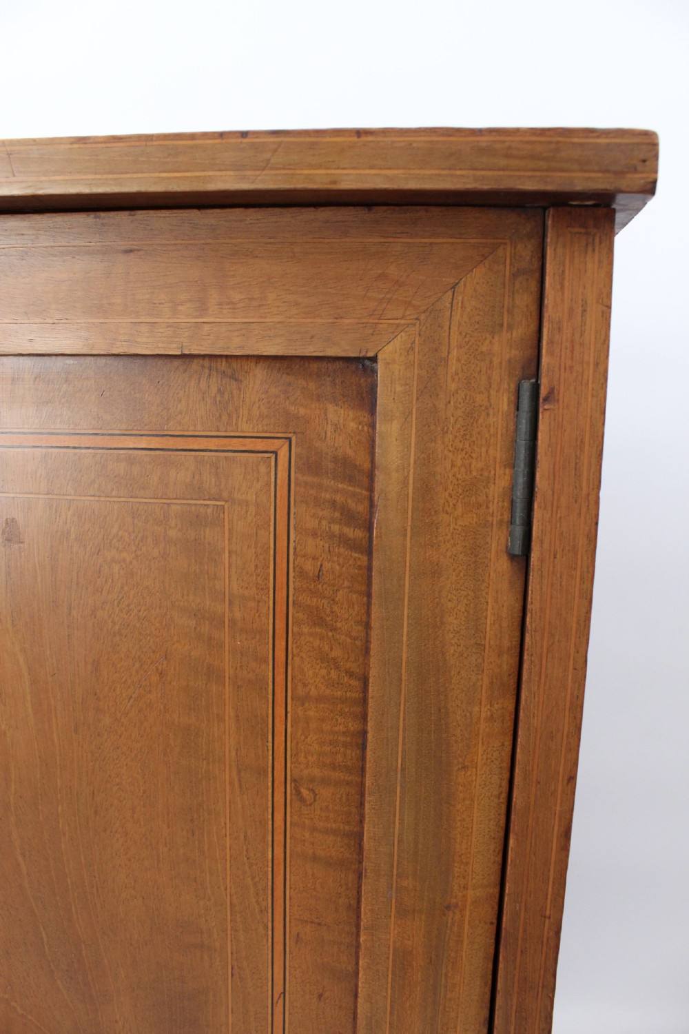 A small Edwardian mahogany bedside cabinet featuring fine boxwood string inlay on the single cupboard door and a brass drop handle. View XI