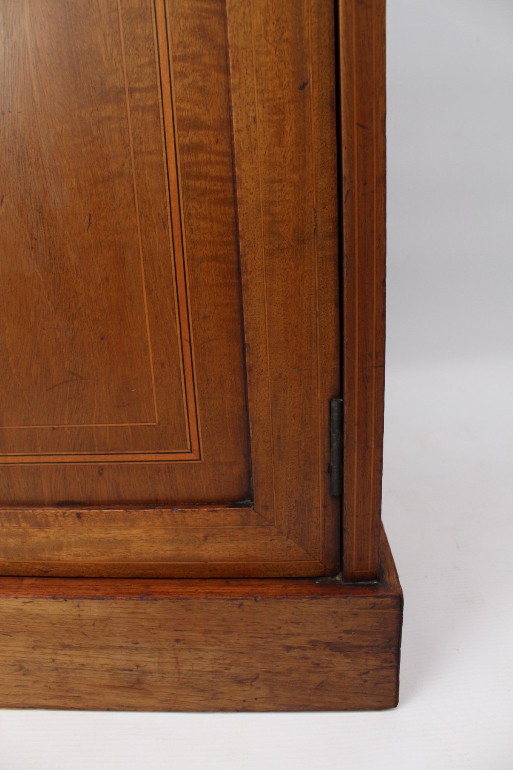 A small Edwardian mahogany bedside cabinet featuring fine boxwood string inlay on the single cupboard door and a brass drop handle. View XII