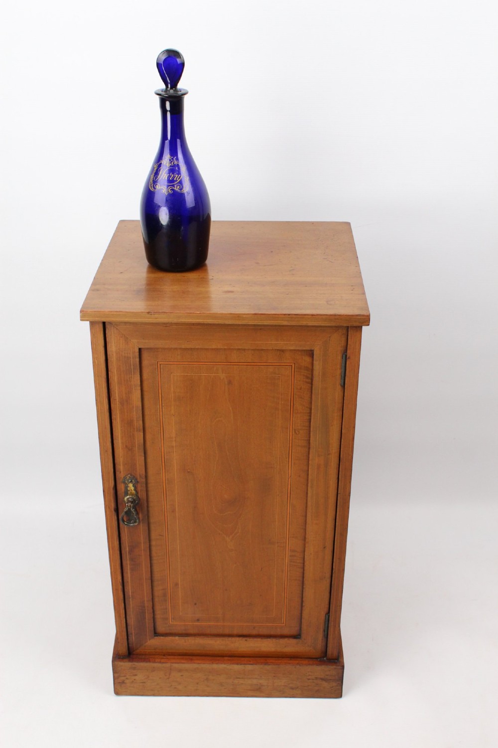 A small Edwardian mahogany bedside cabinet featuring fine boxwood string inlay on the single cupboard door and a brass drop handle. View XIII