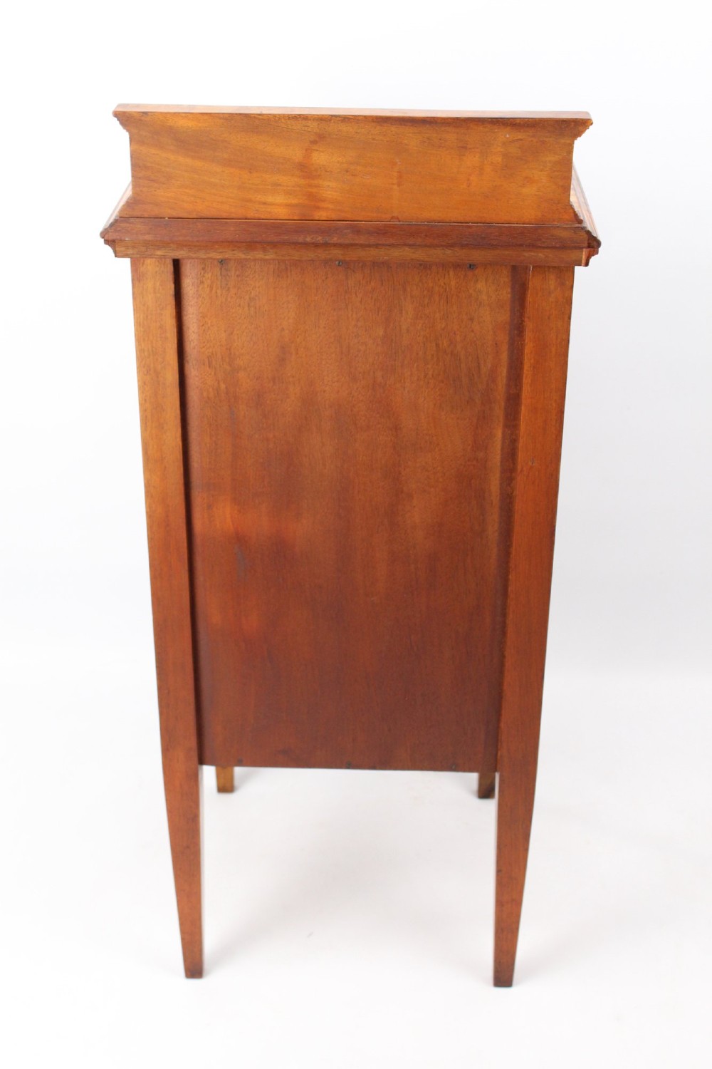 An Edwardian burr walnut bedside cabinet featuring a small gallery top, crossbanded inlaid door panel, drop brass handle, and square tapered legs. View V