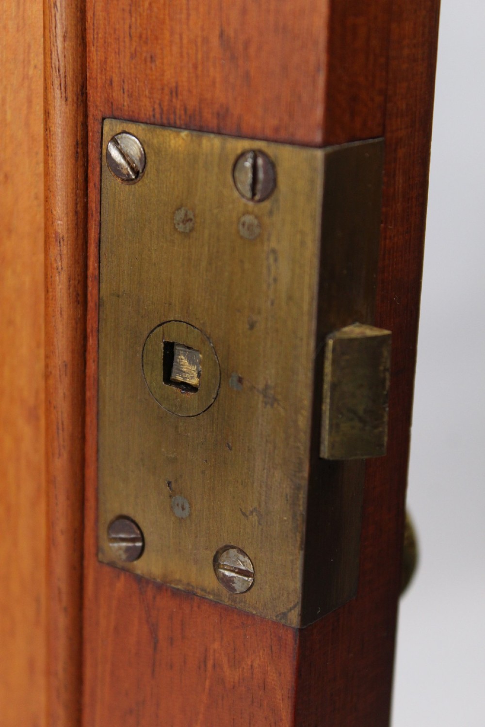 An Edwardian burr walnut bedside cabinet featuring a small gallery top, crossbanded inlaid door panel, drop brass handle, and square tapered legs. View VIII