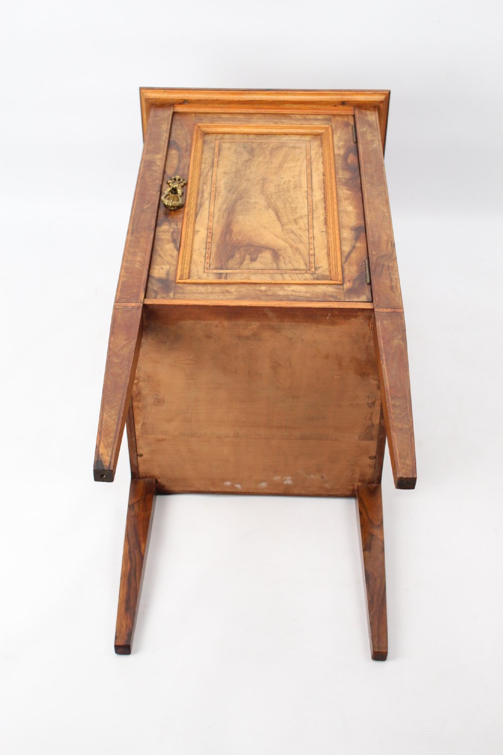 An Edwardian burr walnut bedside cabinet featuring a small gallery top, crossbanded inlaid door panel, drop brass handle, and square tapered legs. View XIII