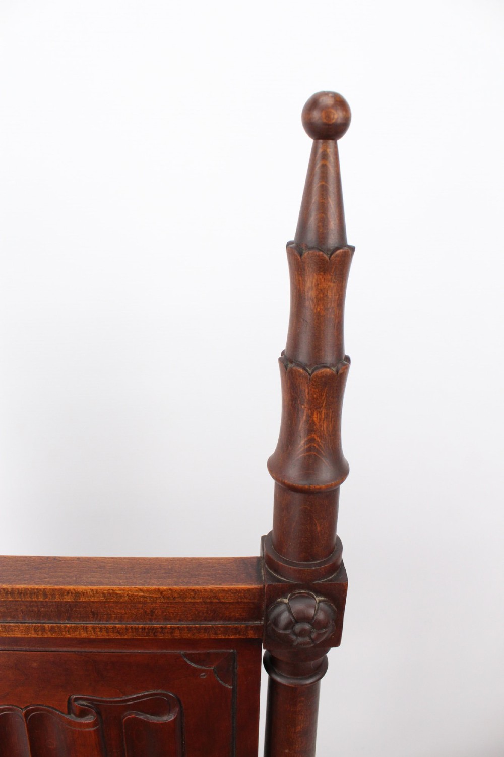 A Victorian Gothic Revival side chair made of dark oak with turned finials, a carved rectangular back panel, pointed arch aprons, and a woven rush seat. View VIII