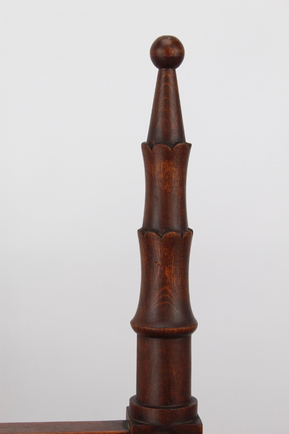 A Victorian Gothic Revival side chair made of dark oak with turned finials, a carved rectangular back panel, pointed arch aprons, and a woven rush seat. View X