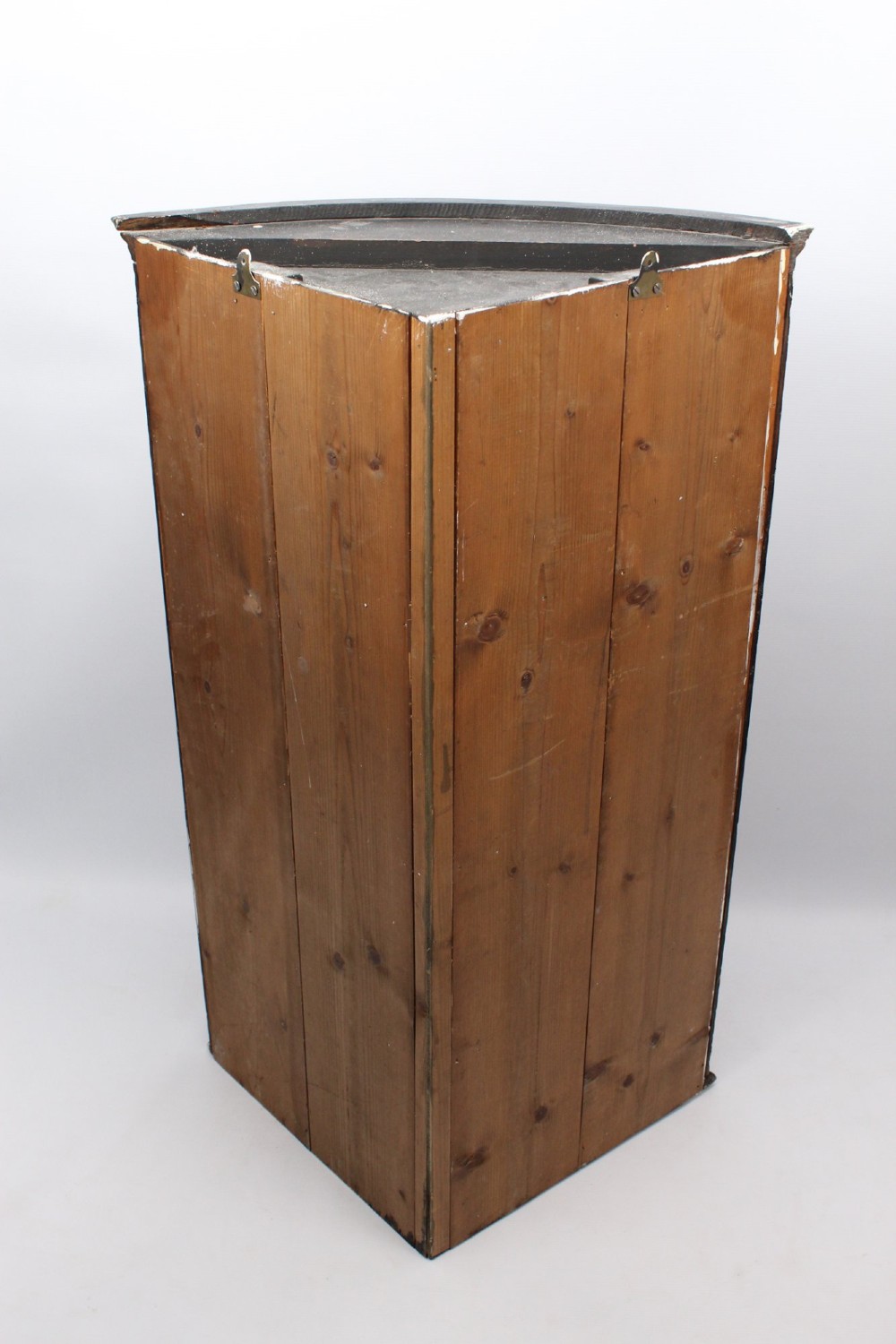 A Georgian mahogany bow front corner cupboard with twin curved doors and decorative brass hinges and keyhole escutcheons. View VI