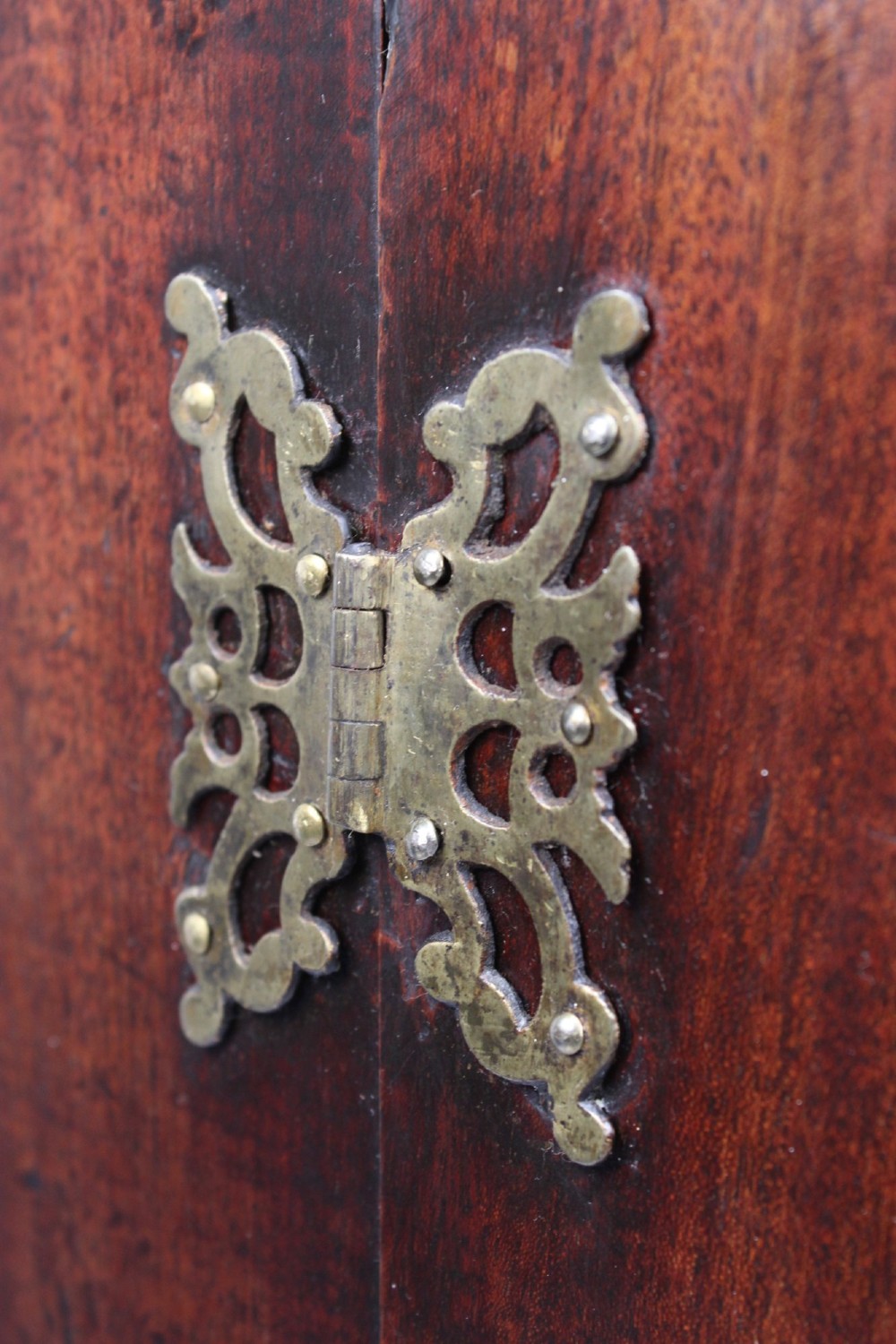 A Georgian mahogany bow front corner cupboard with twin curved doors and decorative brass hinges and keyhole escutcheons. View XI