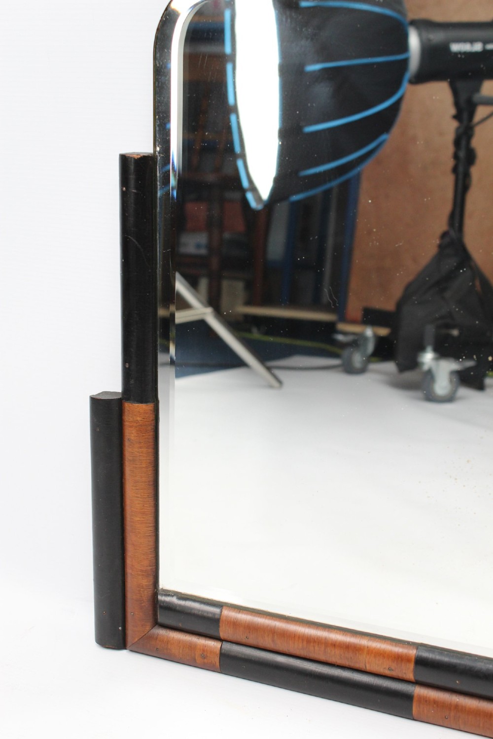 A horizontal rectangular Art Deco wall mirror featuring rounded top corners and a lower frame constructed with alternating walnut and ebonised timber sections. View V