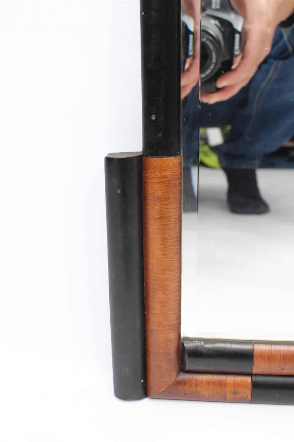 A horizontal rectangular Art Deco wall mirror featuring rounded top corners and a lower frame constructed with alternating walnut and ebonised timber sections. View VI