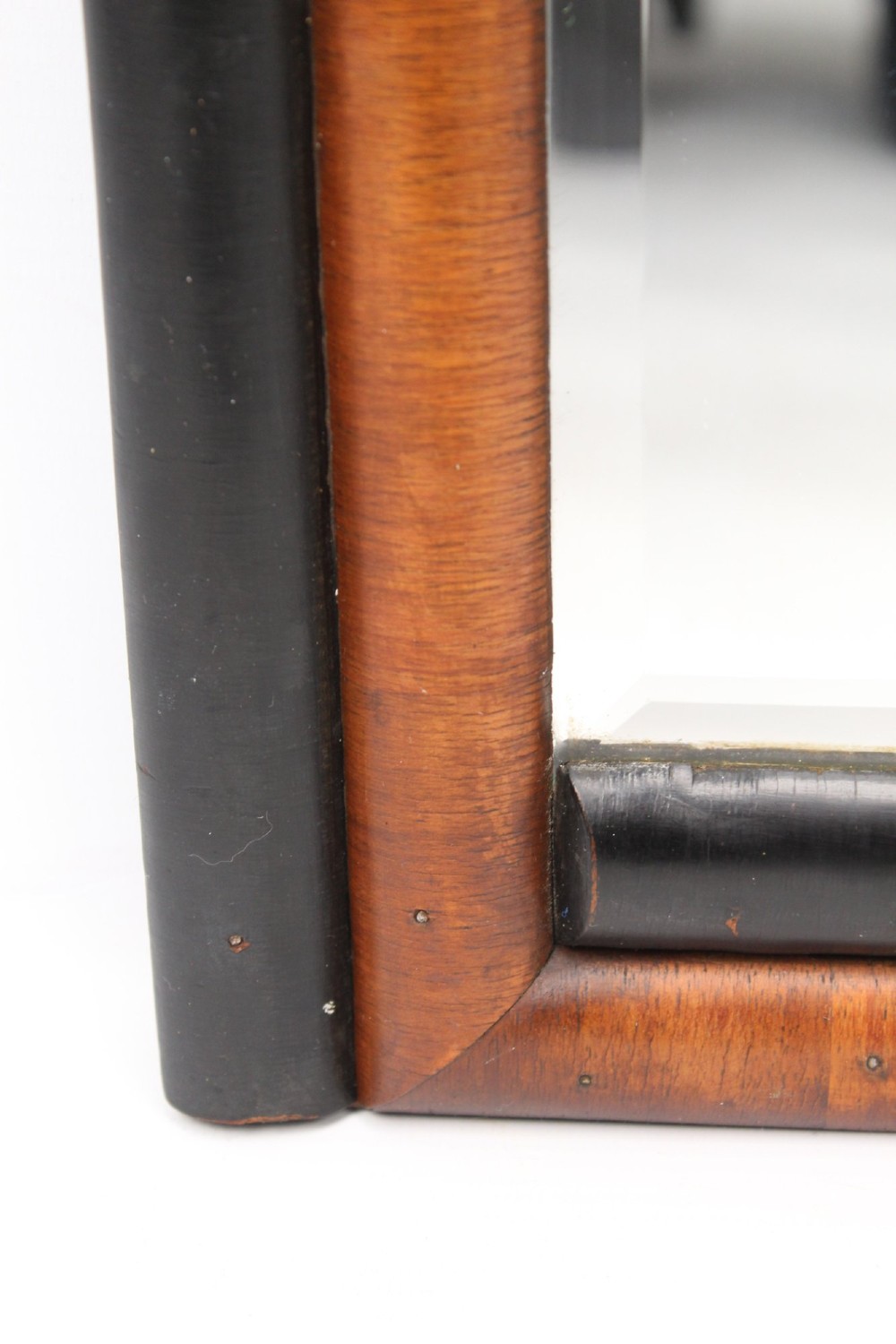 A horizontal rectangular Art Deco wall mirror featuring rounded top corners and a lower frame constructed with alternating walnut and ebonised timber sections. View VII