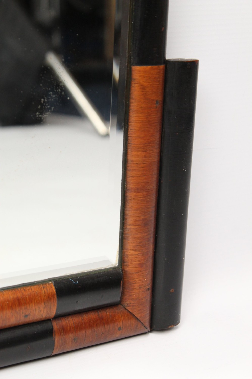A horizontal rectangular Art Deco wall mirror featuring rounded top corners and a lower frame constructed with alternating walnut and ebonised timber sections. View IX