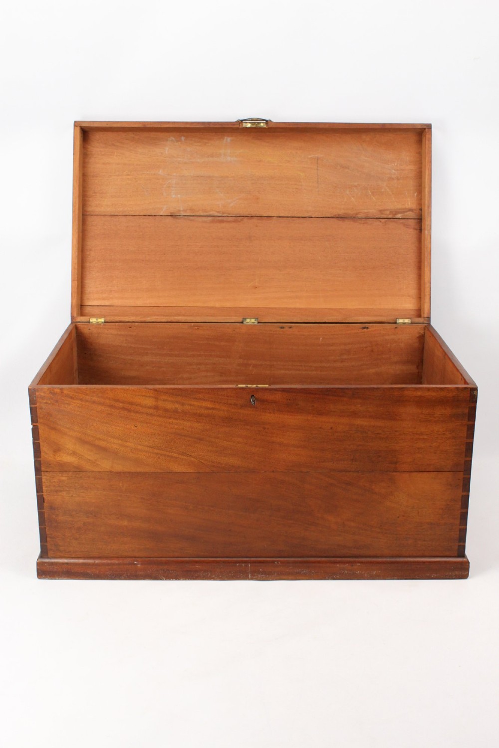 A rectangular Victorian mahogany storage chest featuring exposed dovetail corner joints, a flat hinged lid, and a central brass handle. View II