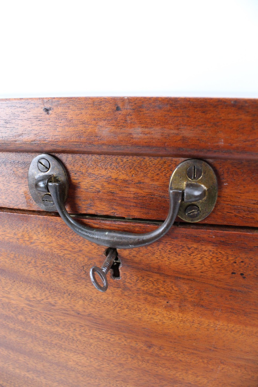 A rectangular Victorian mahogany storage chest featuring exposed dovetail corner joints, a flat hinged lid, and a central brass handle. View VIII