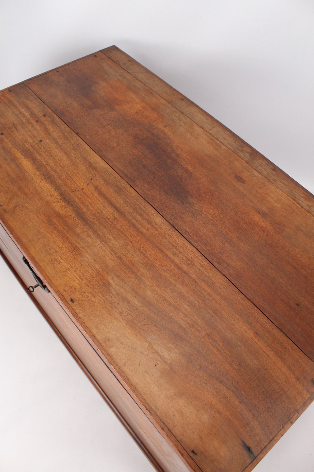 A rectangular Victorian mahogany storage chest featuring exposed dovetail corner joints, a flat hinged lid, and a central brass handle. View XII