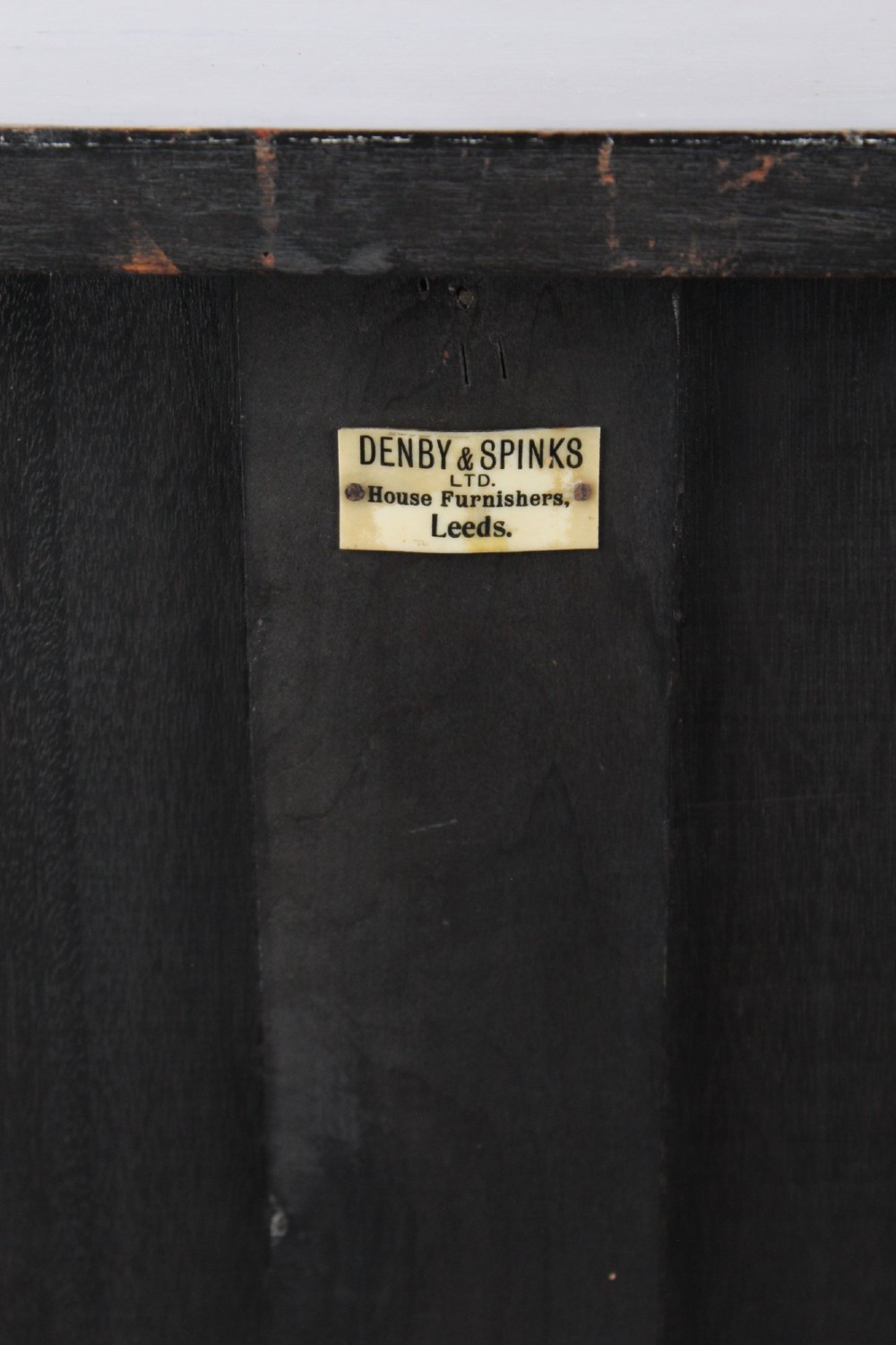 An Edwardian dark mahogany pedestal cabinet featuring an oval flame mahogany panel, carved scroll frieze, and square tapered legs. View XIII
